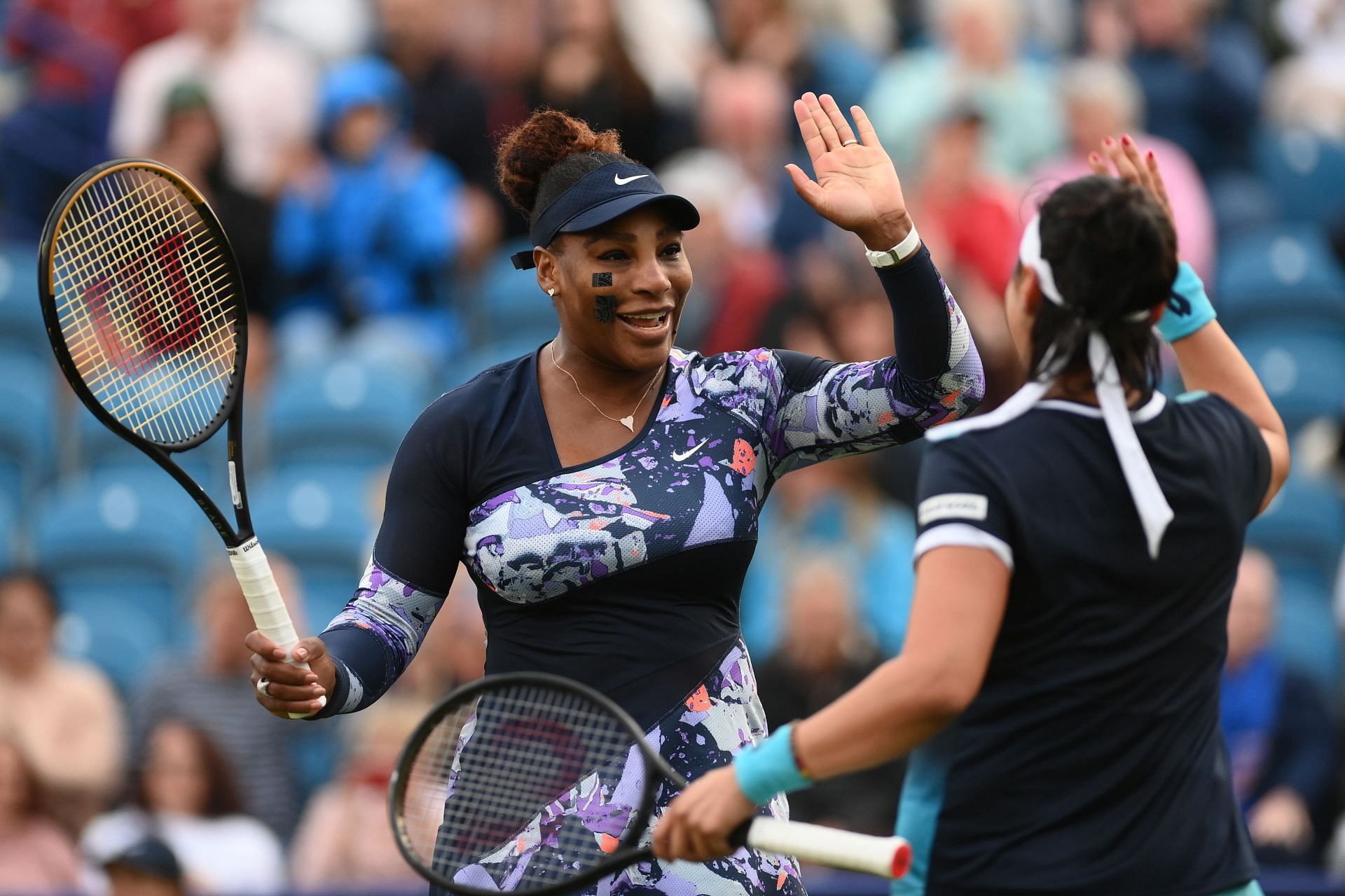 Serena Williams and Ons Jabeiur during their match in Eastbourne