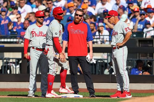 Former Philadelphia Phillies manager Joe Girardi talks to Bryce Harper