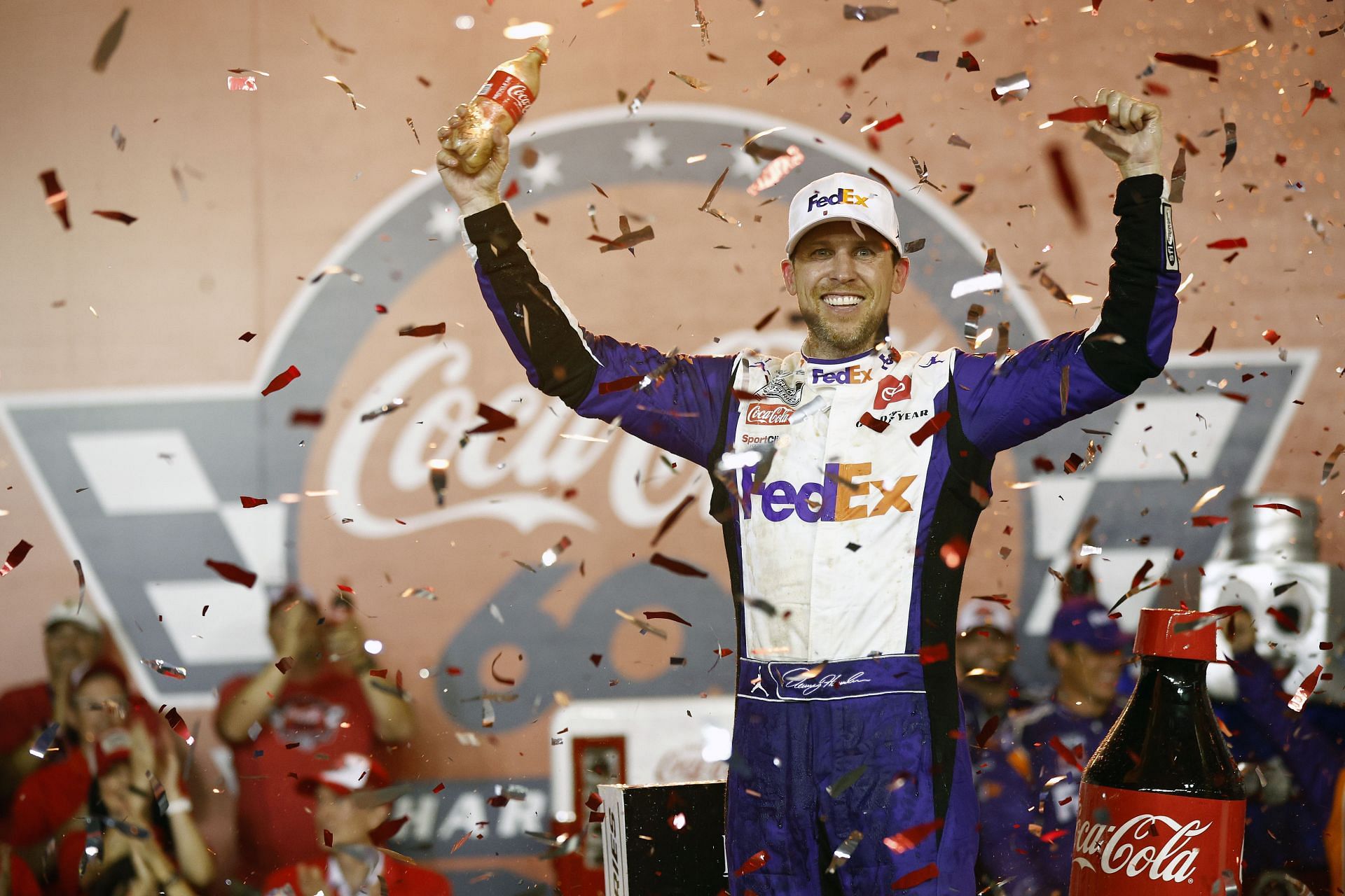 Denny Hamlin celebrates in Victory Lane after winning the NASCAR Cup Series Coca-Cola 600 at Charlotte Motor Speedway