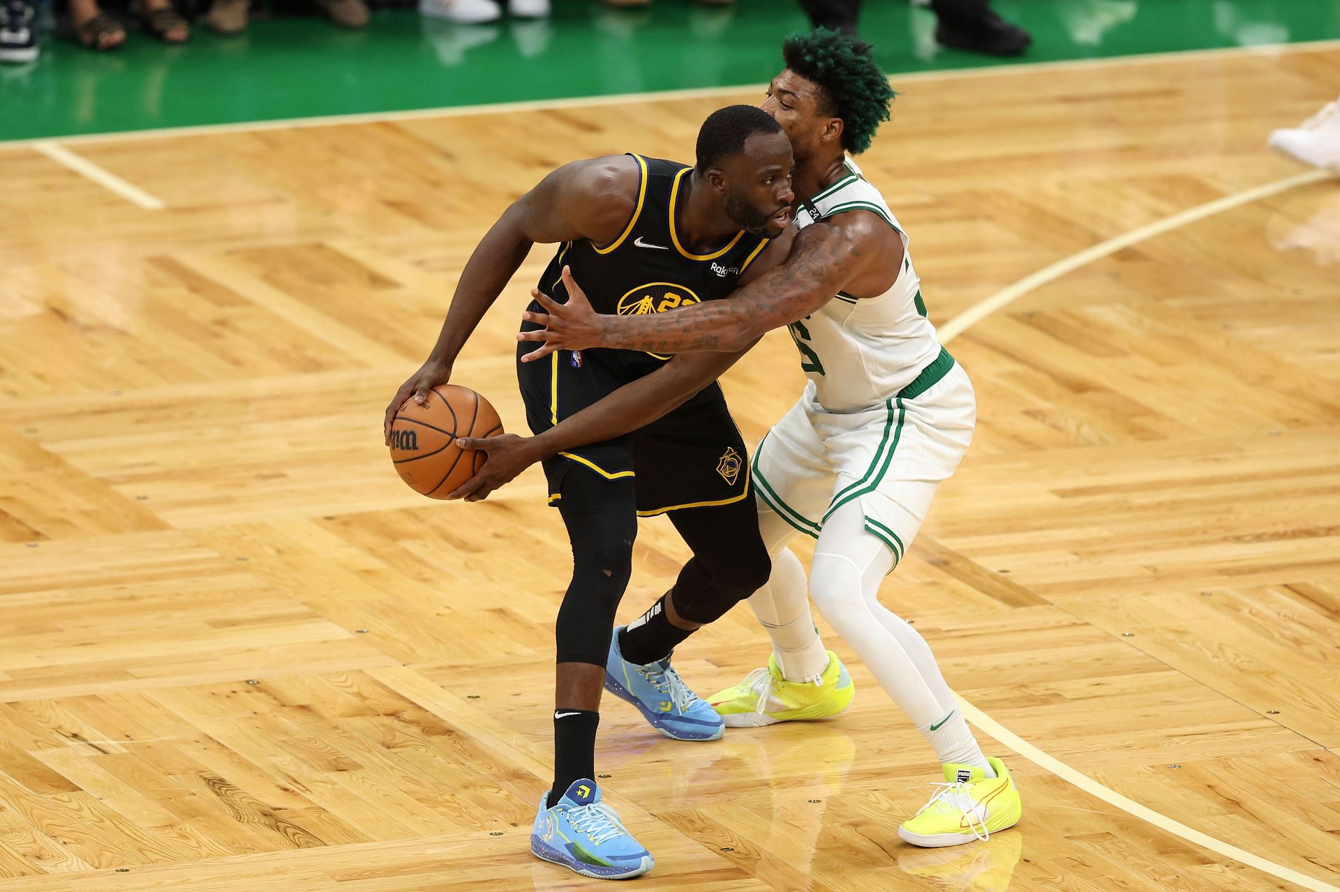 Draymond Green (left) defended by Marcus Smart in Game Three of the NBA Finals
