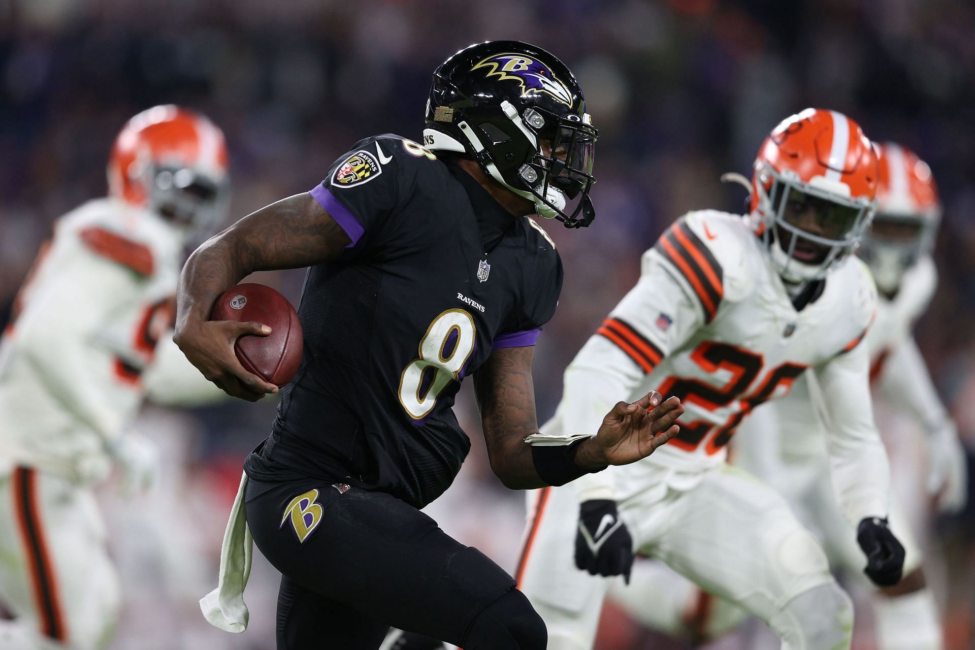 Baltimore Ravens quarterback Lamar Jackson (8) takes to the field with a  member of the military as part of Salute to Service before an NFL football  game against the Carolina Panthers, Sunday