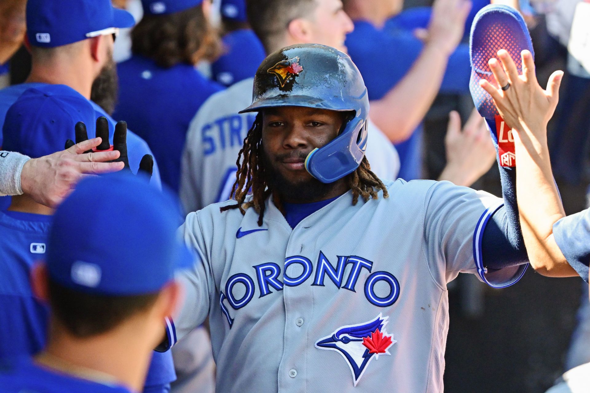 Vladimir Guerrero Jr. celebrates with teammates after scoring a run during today&#039;s Toronto Blue Jays v Chicago White Sox game.
