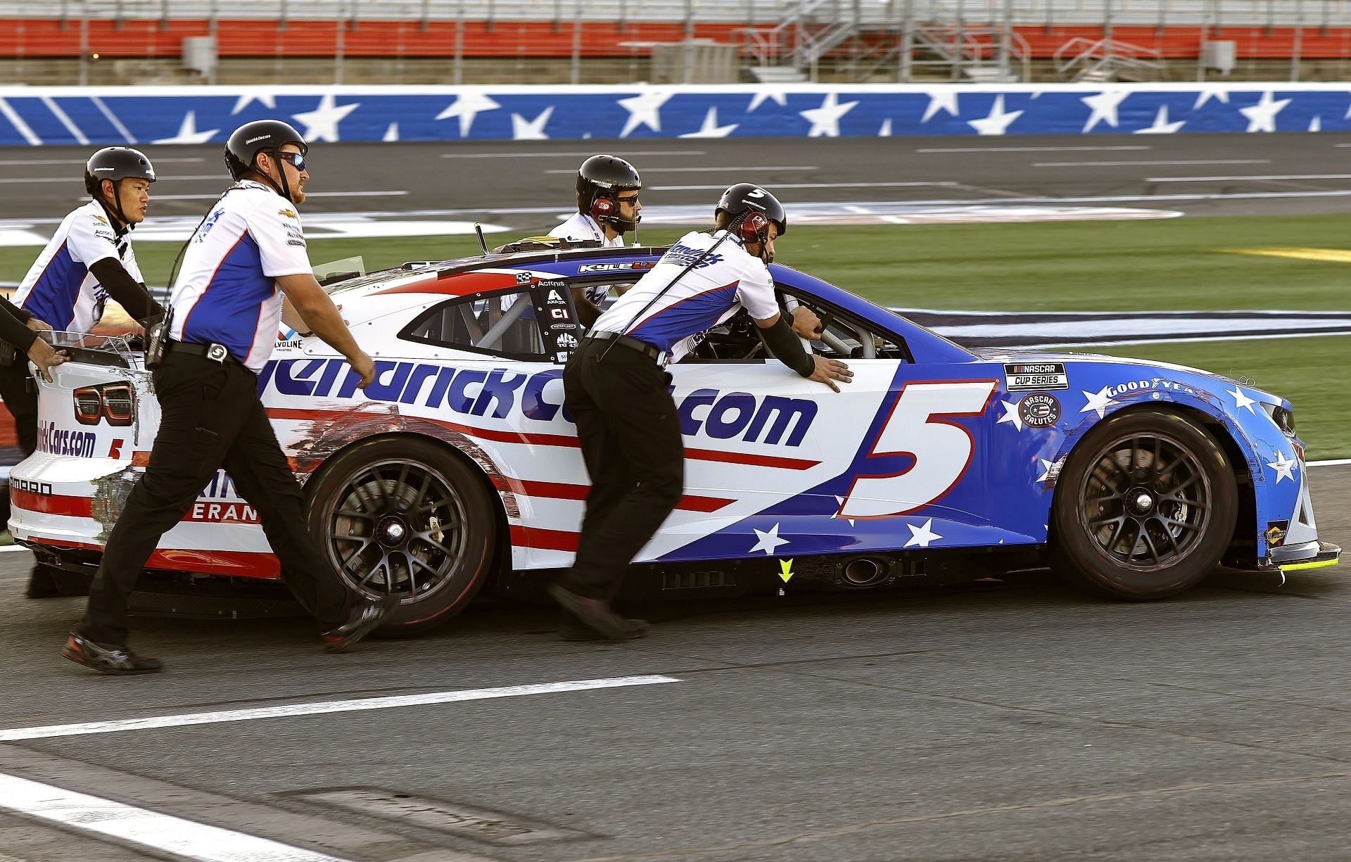 Crew members push the damaged #5 Chevrolet driven by Kyle Larson to the garage area during practice for the 2022 NASCAR Cup Series Coca-Cola 600 at Charlotte Motor Speedway in Concord, North Carolina. (Photo by Buda Mendes/Getty Images)