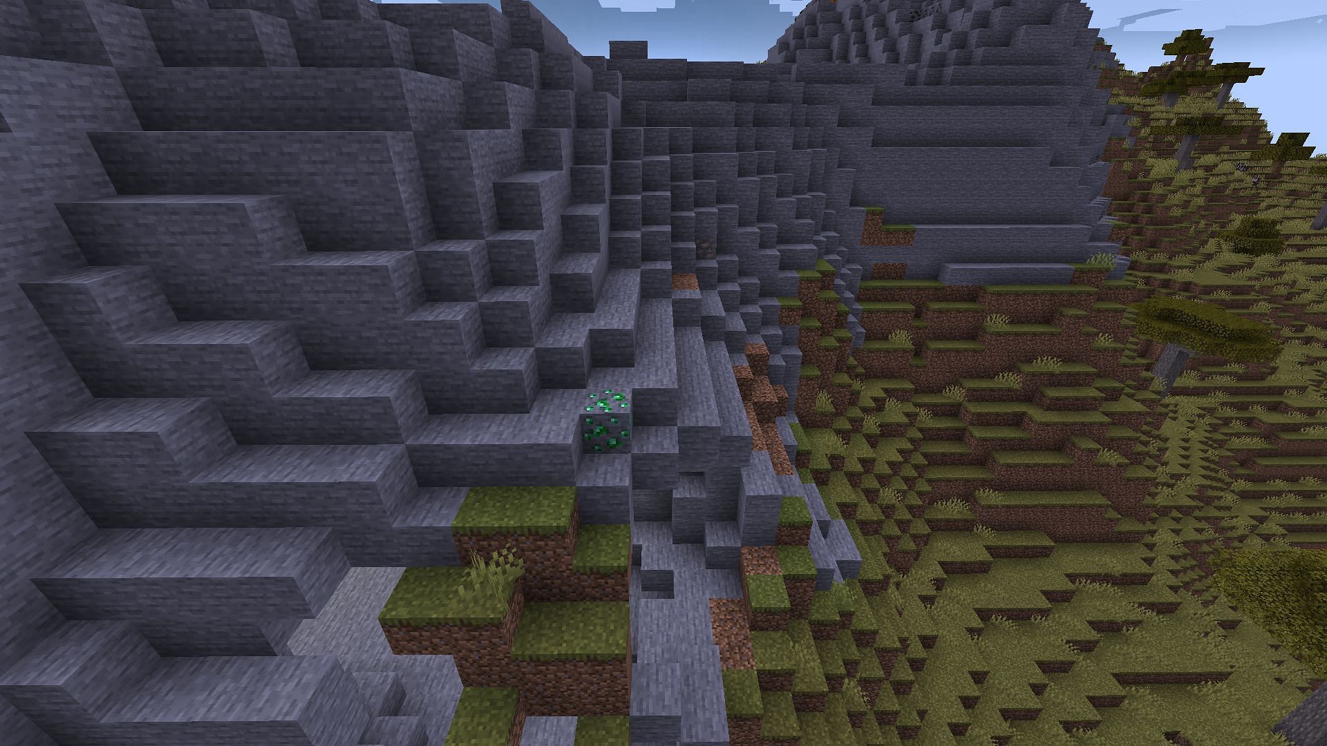 A single emerald ore in a stony peak, almost 10k blocks from spawn (Image via Minecraft)