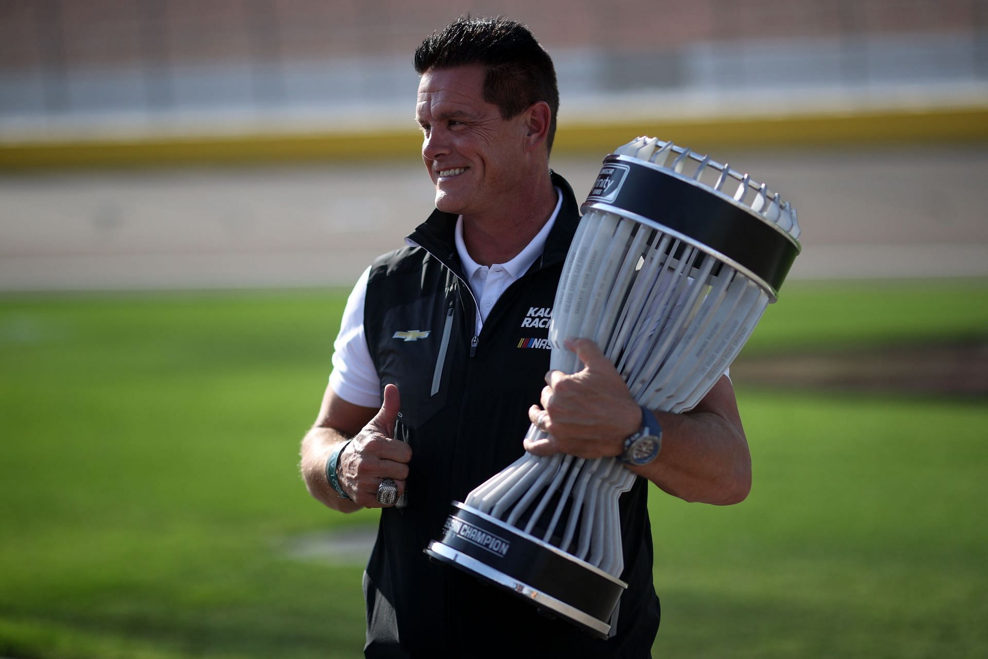 Matt Kaulig poses for photos with the 2021 Xfinity Series Regular Season Championship trophy before the Xfinity Series Alsco Uniforms 302 at Las Vegas Motor Speedway (Photo by Chris Graythen/Getty Images)