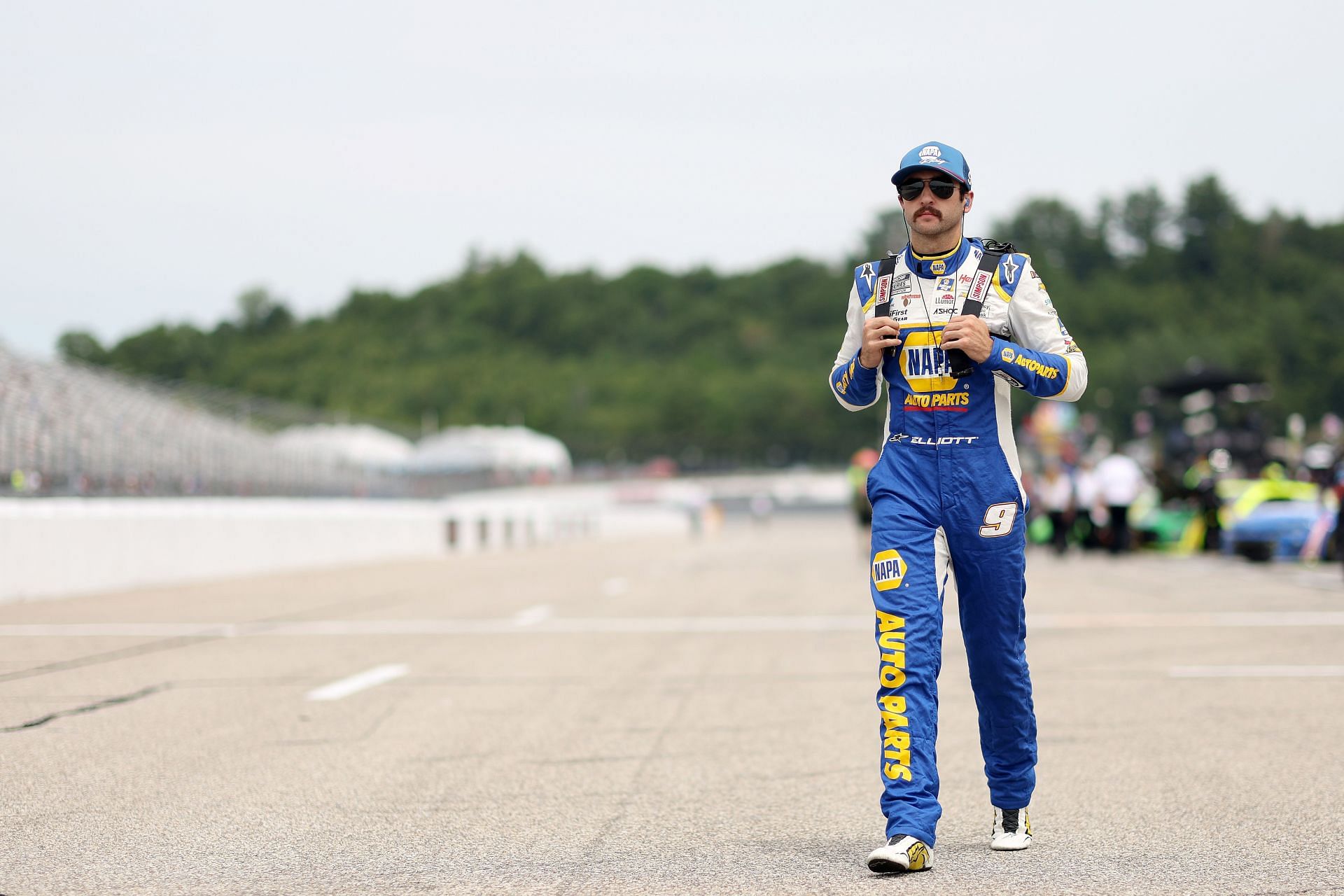 Chase Elliott walks the grid during qualifying for the NASCAR Cup Series Ambetter 301 at New Hampshire Motor Speedway