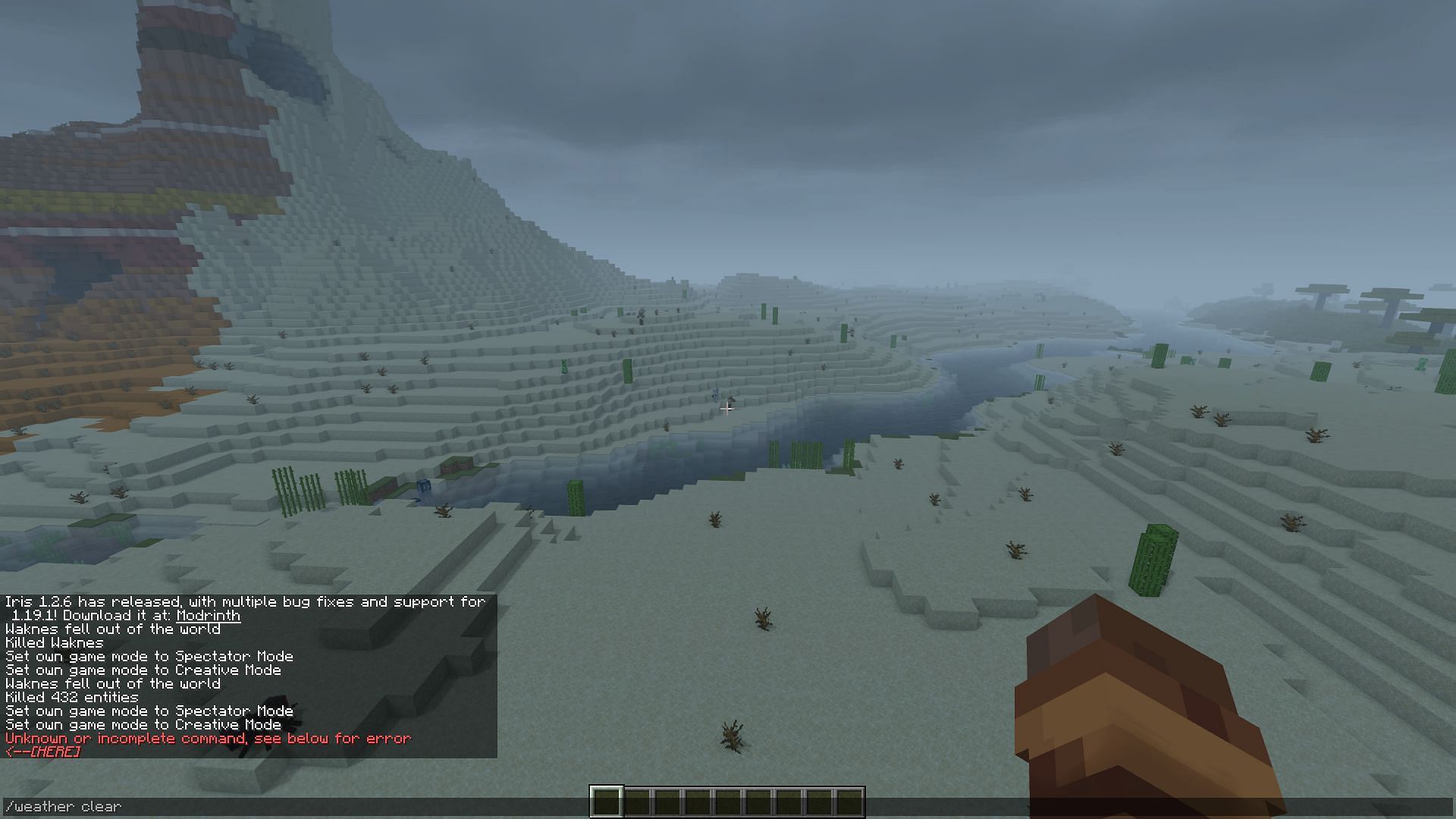 The /weather clear command being used to clear the overcast skies in a desert biome (Image via Minecraft)