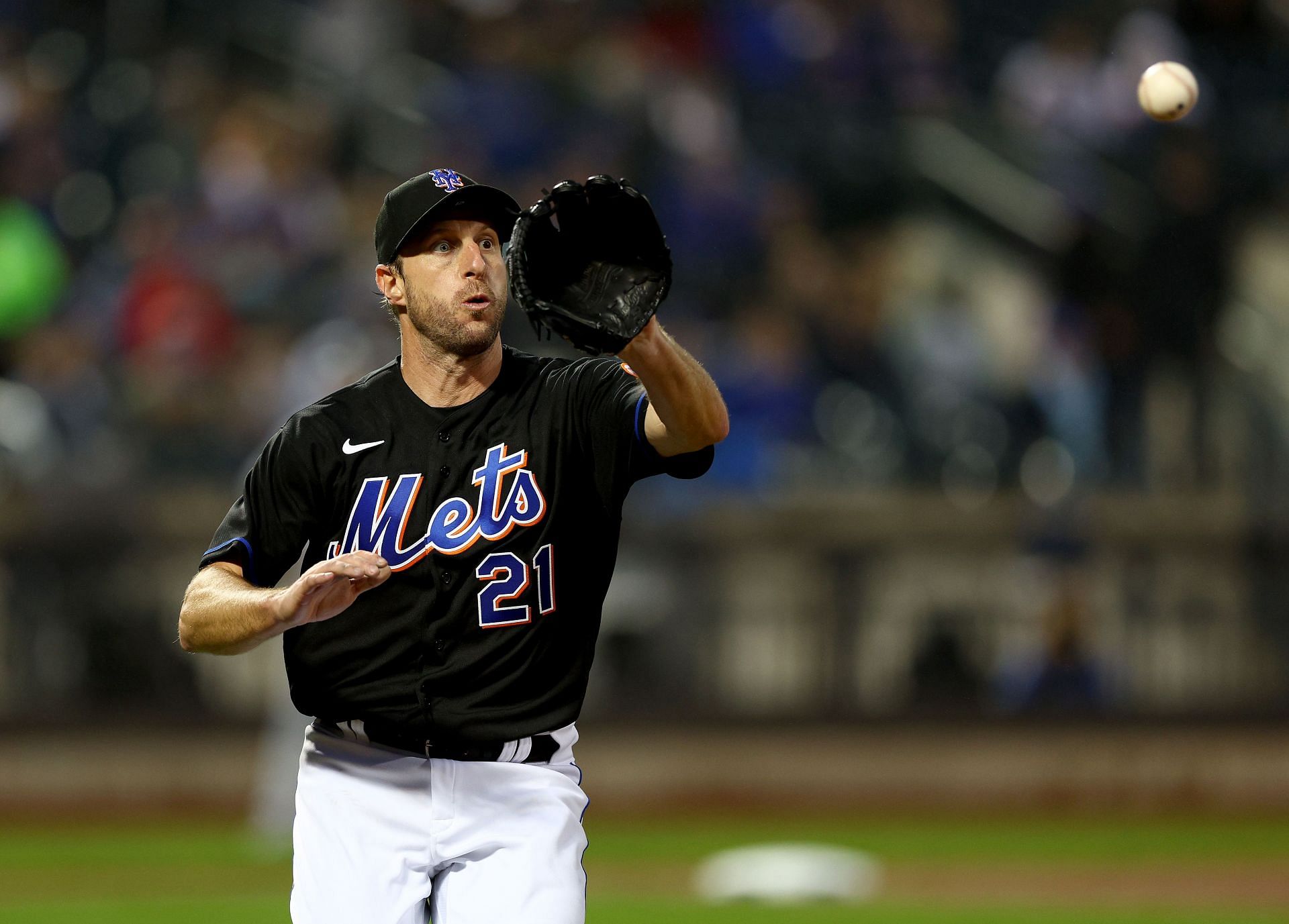 Max Scherzer of the New York Mets gets the out at first against the Seattle Mariners