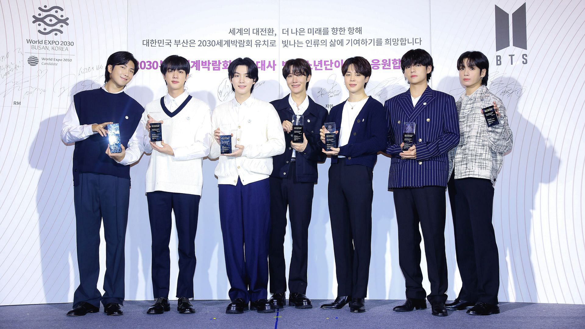 BTS receive plaques after officially being appointed as global abassadors for World Expo 2030 Busan (Image via BIGHIT MUSIC)