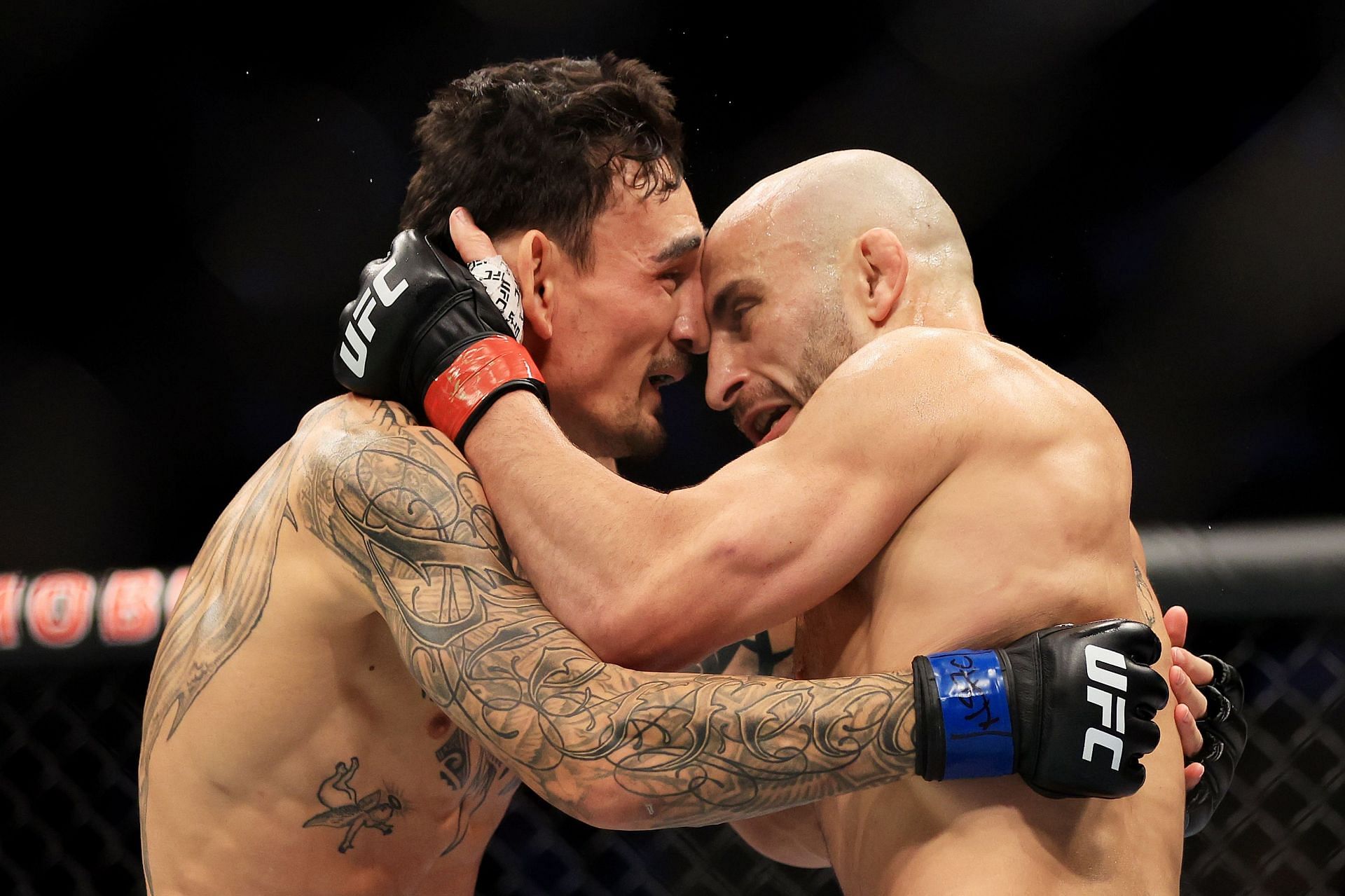 Alexander Volkanovski and Max Holloway embrace each other following their trilogy fight