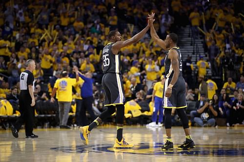 Kevin Durant high fives Andre Iguodala of the Golden State Warriors