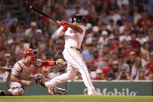 Rafael Devers of the Boston Red Sox hits a two-run RBI single against the St. Louis Cardinals