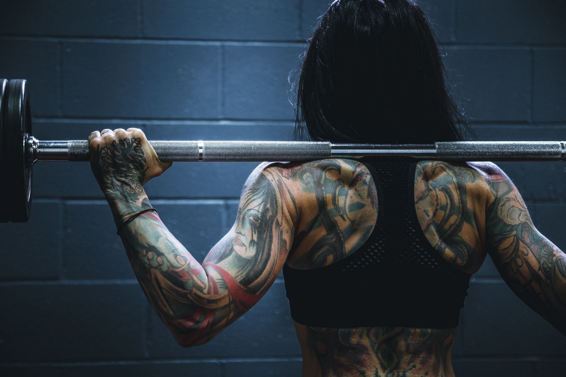 Strength-building exercises can help enhance and shape your muscles. (Image via Unsplash / Alora Griffiths)