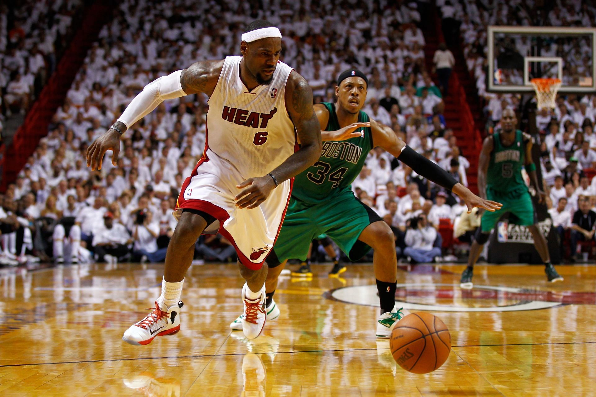 LeBron James #6 of the Miami Heat chases down a loose ball in the second half against Paul Pierce #34 of the Boston Celtics