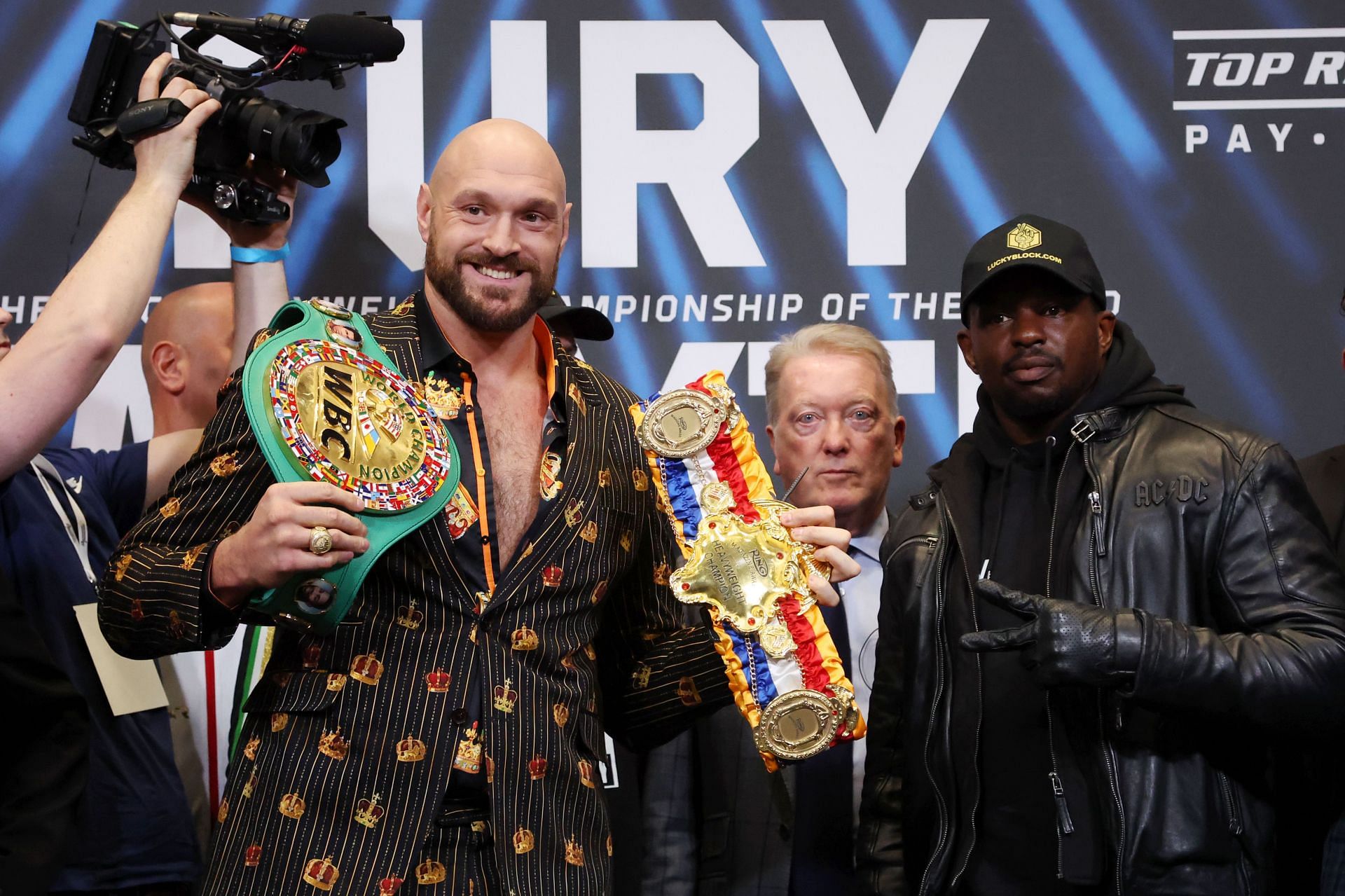 Tyson Fury (left), Frank Warren (center), and Dillian Whyte (right) [Images via Getty]