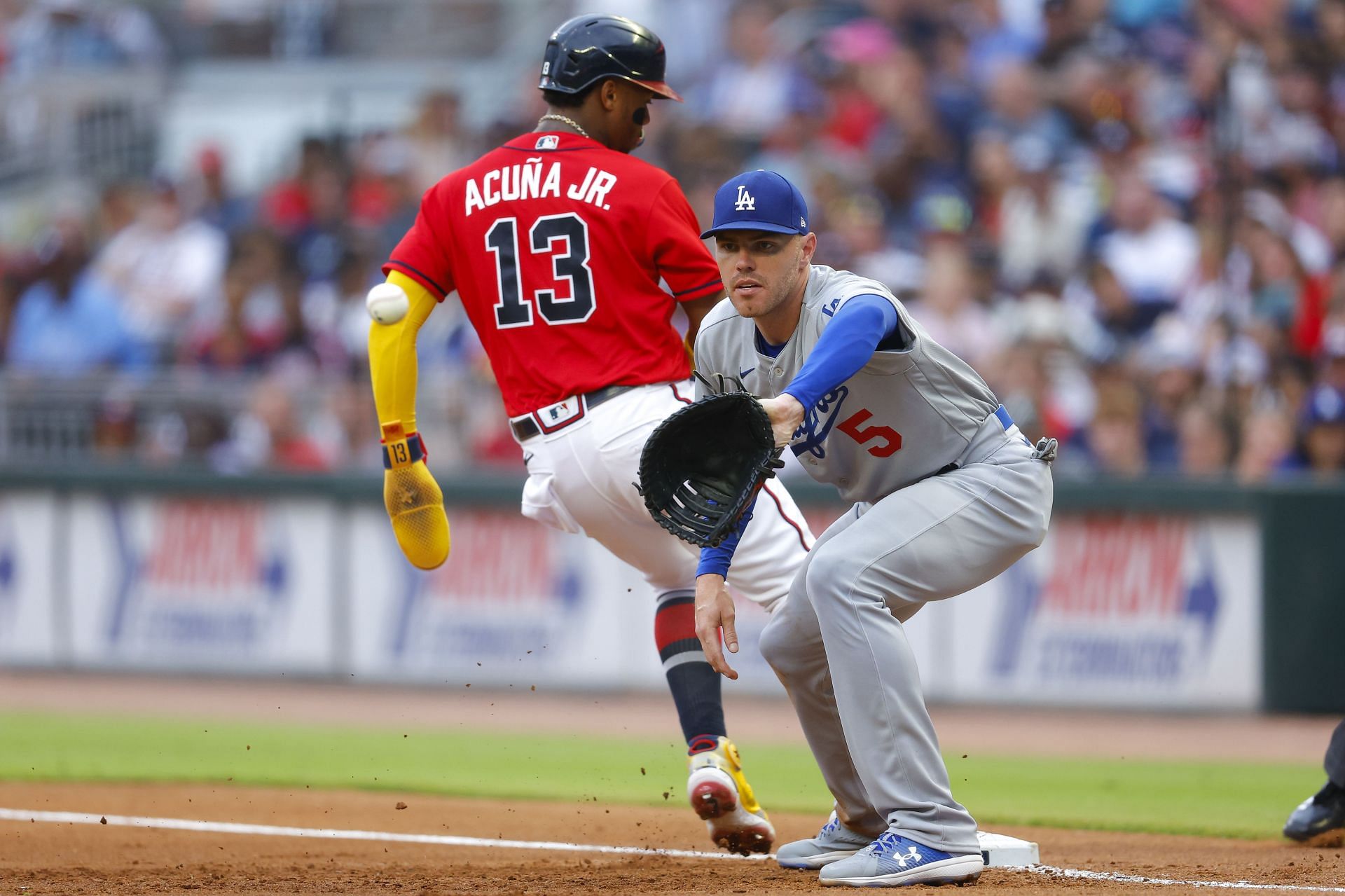 Freddie Freeman of the Los Angeles Dodgers takes the throw during the first inning at Truist Park