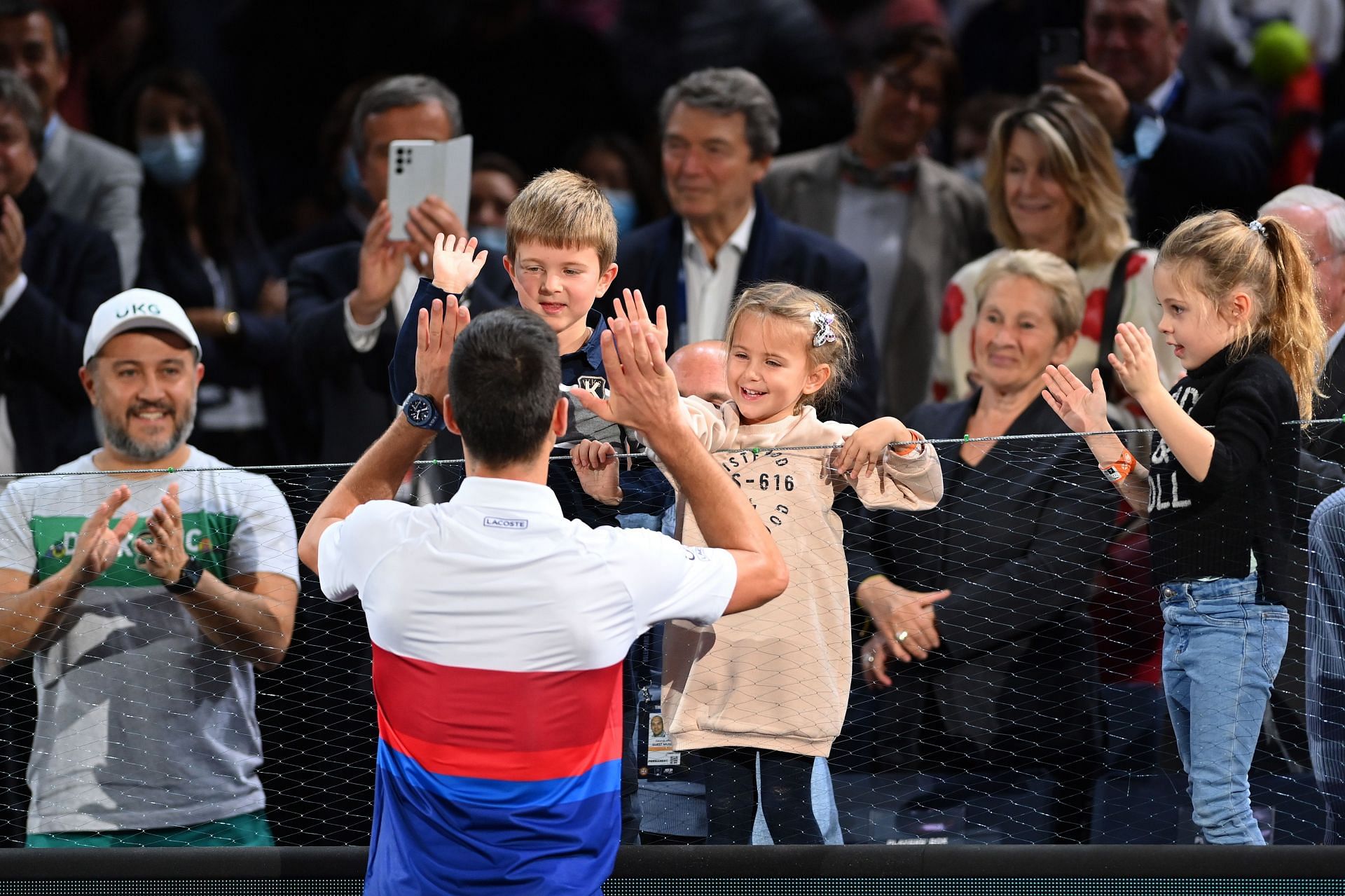 Novak Djokovic giving his kids a high-five after his 2021 Paris Masters win