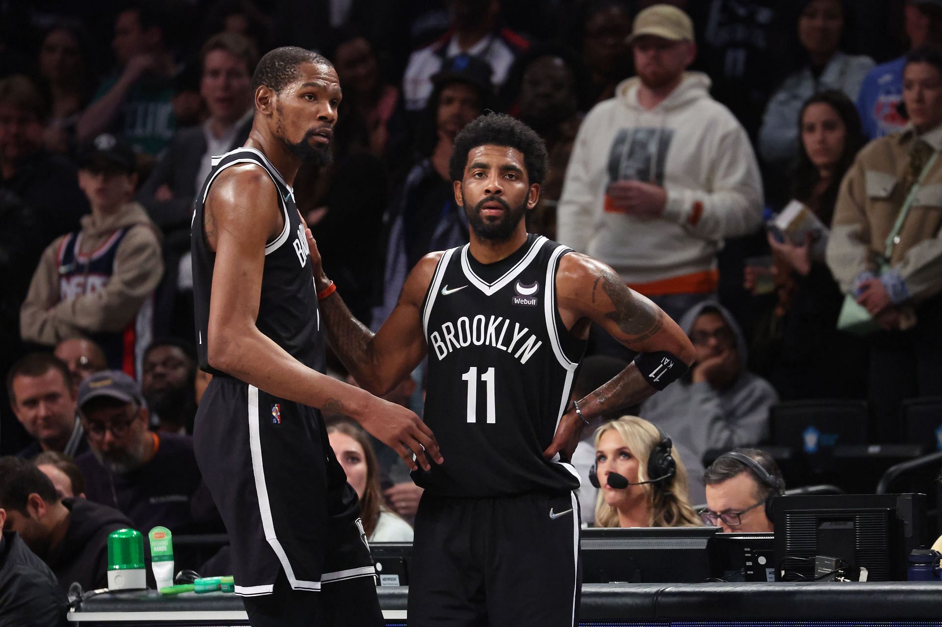 Kevin Durant #7 and Kyrie Irving #11 of the Brooklyn Nets look on in the final seconds of their 109-103 loss against the Boston Celtics during Game Three of the Eastern Conference First Round NBA Playoffs at Barclays Center on April 23, 2022 in New York City.
