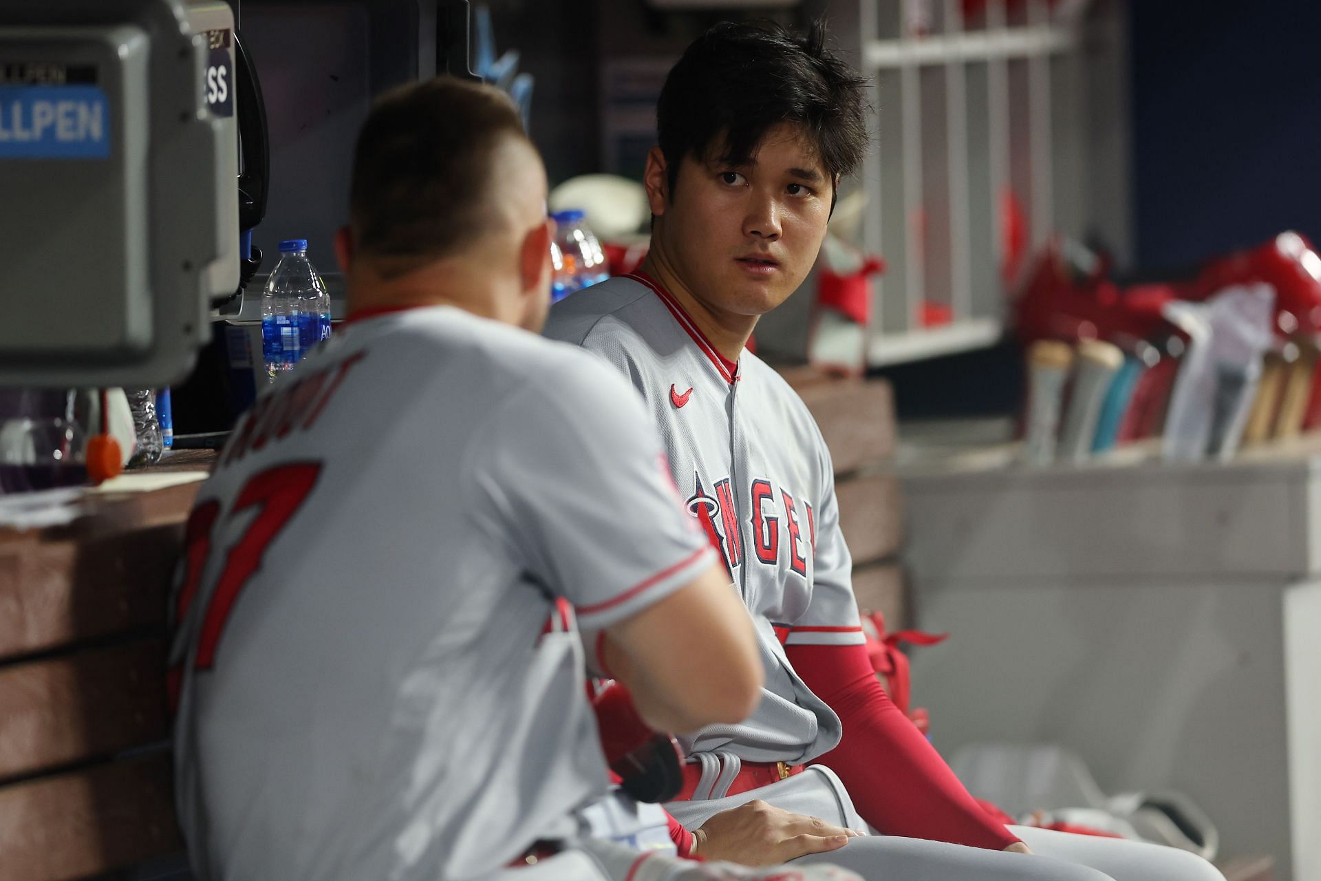 Shohei Ohtani and Mike Trout of the Los Angeles Angels talk in the dugout