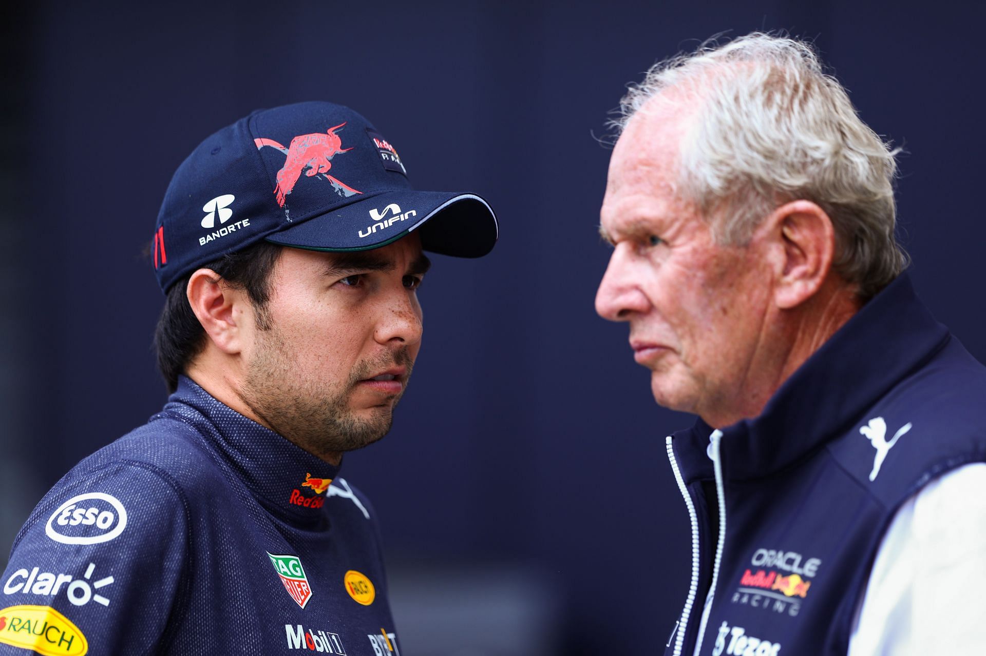 Sergio Perez and Red Bull Racing Team Consultant Dr Helmut Marko during practice ahead of the F1 Grand Prix of Austria at Red Bull Ring on July 09, 2022 in Spielberg, Austria. (Photo by Clive Rose/Getty Images)