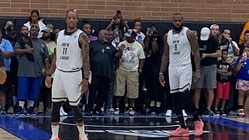 DeMar DeRozan and LeBron James look on at a Drew League game