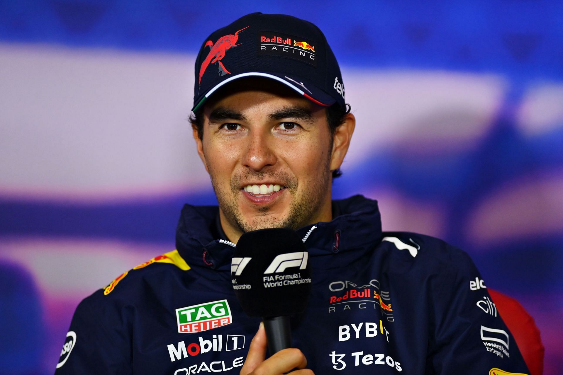 Sergio Perez speaks to the media after his P2 finish at the 2022 F1 British GP. (Photo by Dan Mullan/Getty Images)