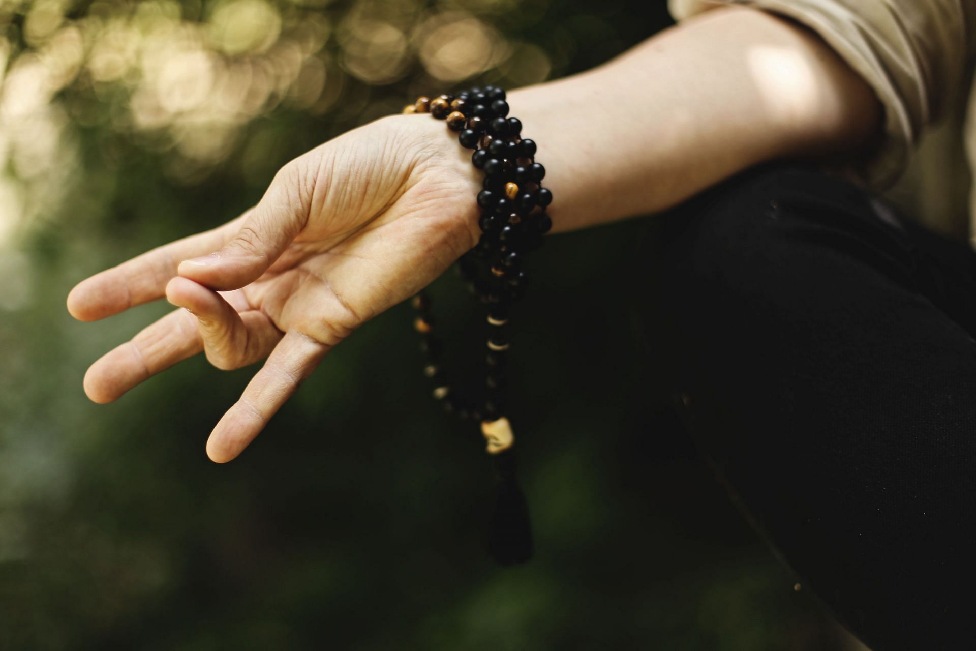 Hand motions known as mudras help direct energy flow to certain areas of the brain. (Image via Unsplash/ Ksenia Makagonova)