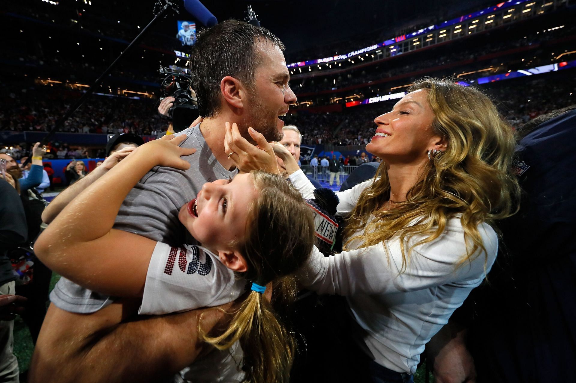 Tom Brady celebrating a Super Bowl win with wife Gisele Bundchen and kids