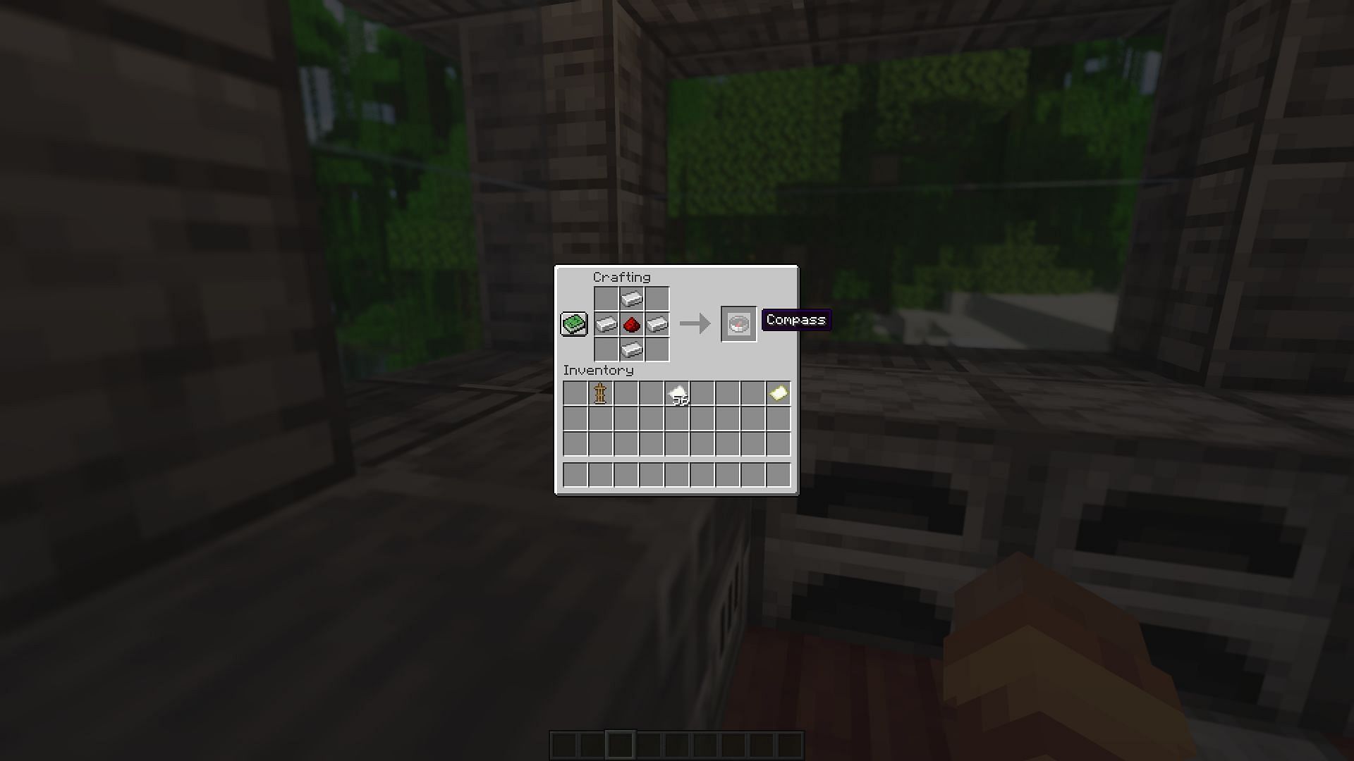 The crafting recipe for a compass (Image via Minecraft)