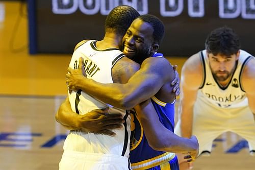 Kevin Durant and Draymond Green share a moment at half court