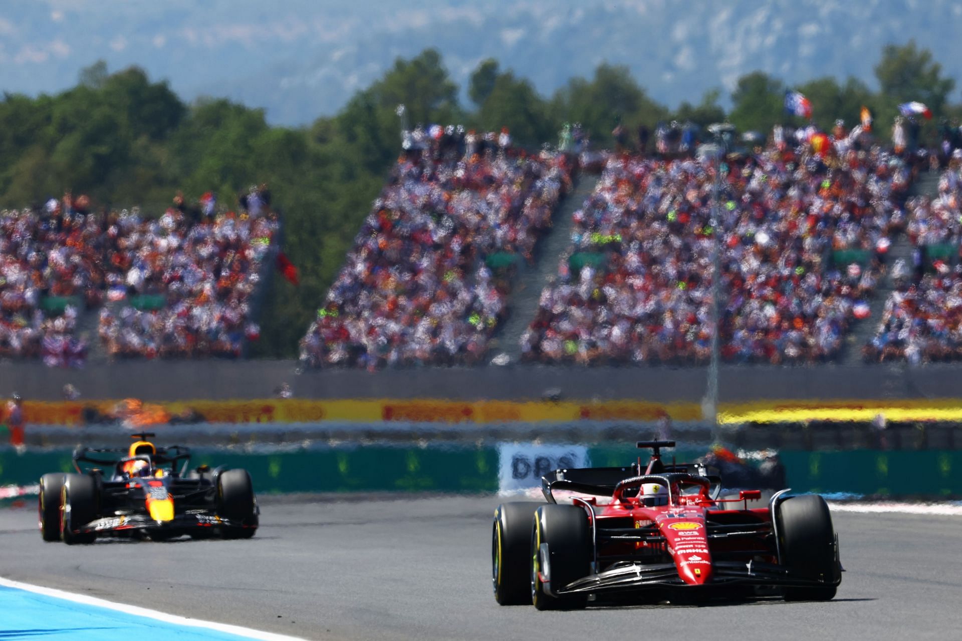 Red Bull driver Max Verstappen (background) and Ferrari driver Charles Leclerc (foreground) in action during the 2022 F1 French GP (Photo by Mark Thompson/Getty Images)
