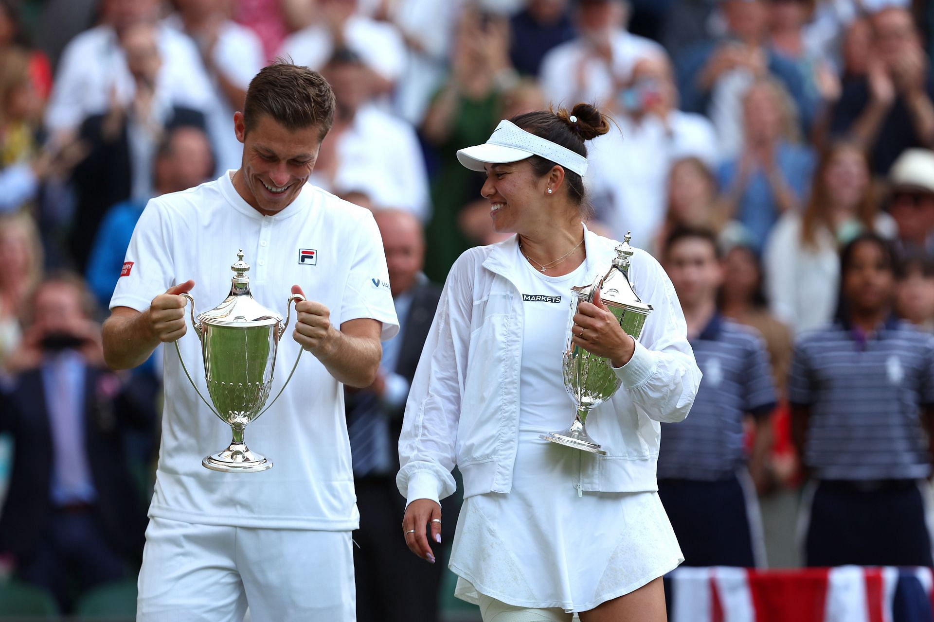 Neal Skupski and Desirae Krawczyk with the 2022 Wimbledon mixed&#039;s doubles trophy