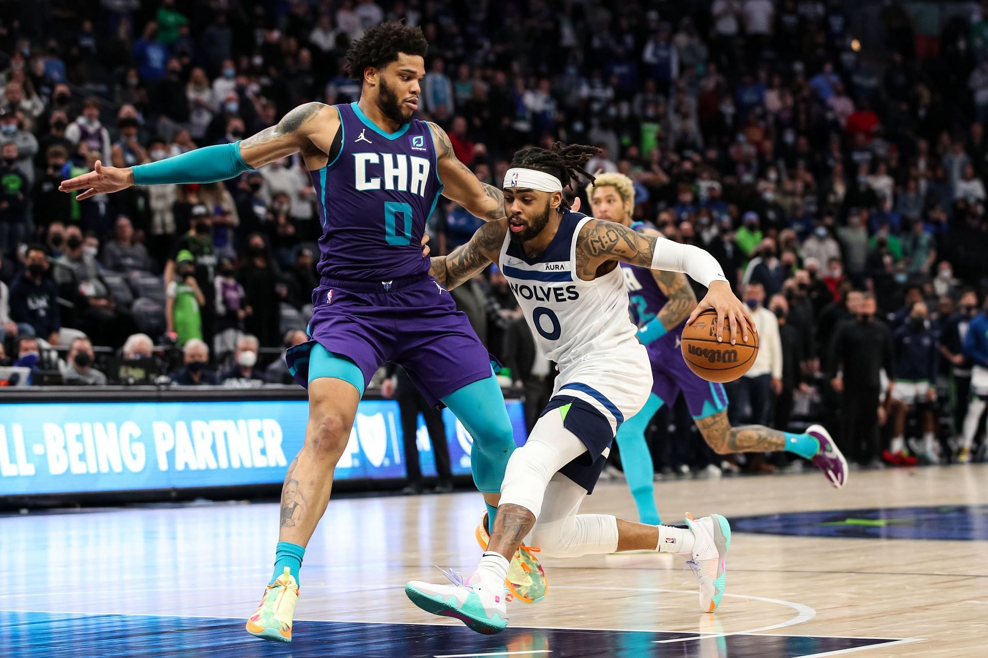 Miles Bridges of the Charlotte Hornets defends D&#039;Angelo Russell of the Minnesota Timberwolves.