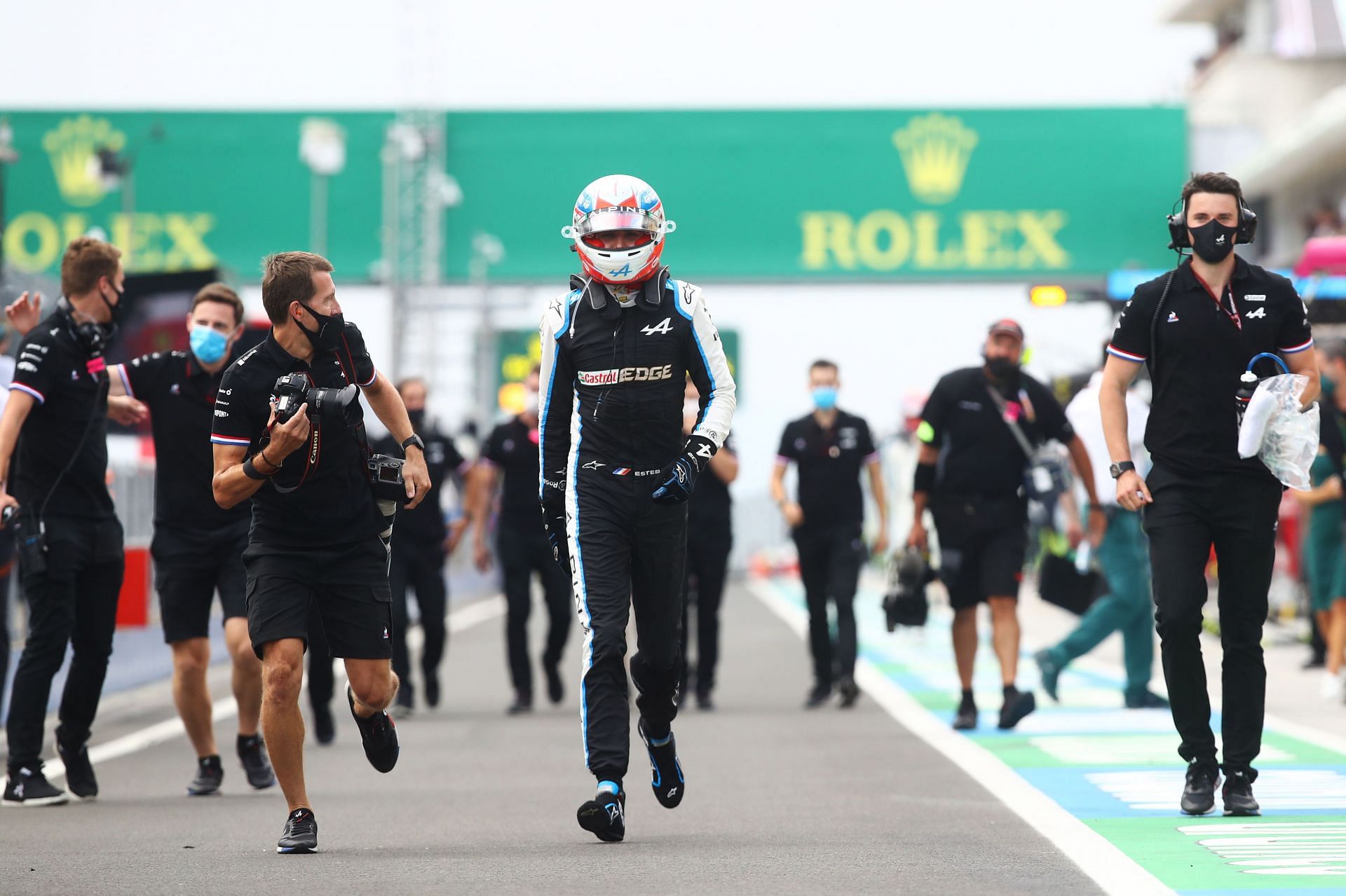 Esteban Ocon runs in the pitlane after winning the 2021 F1 Hungarian GP (Photo by Mark Thompson/Getty Images)