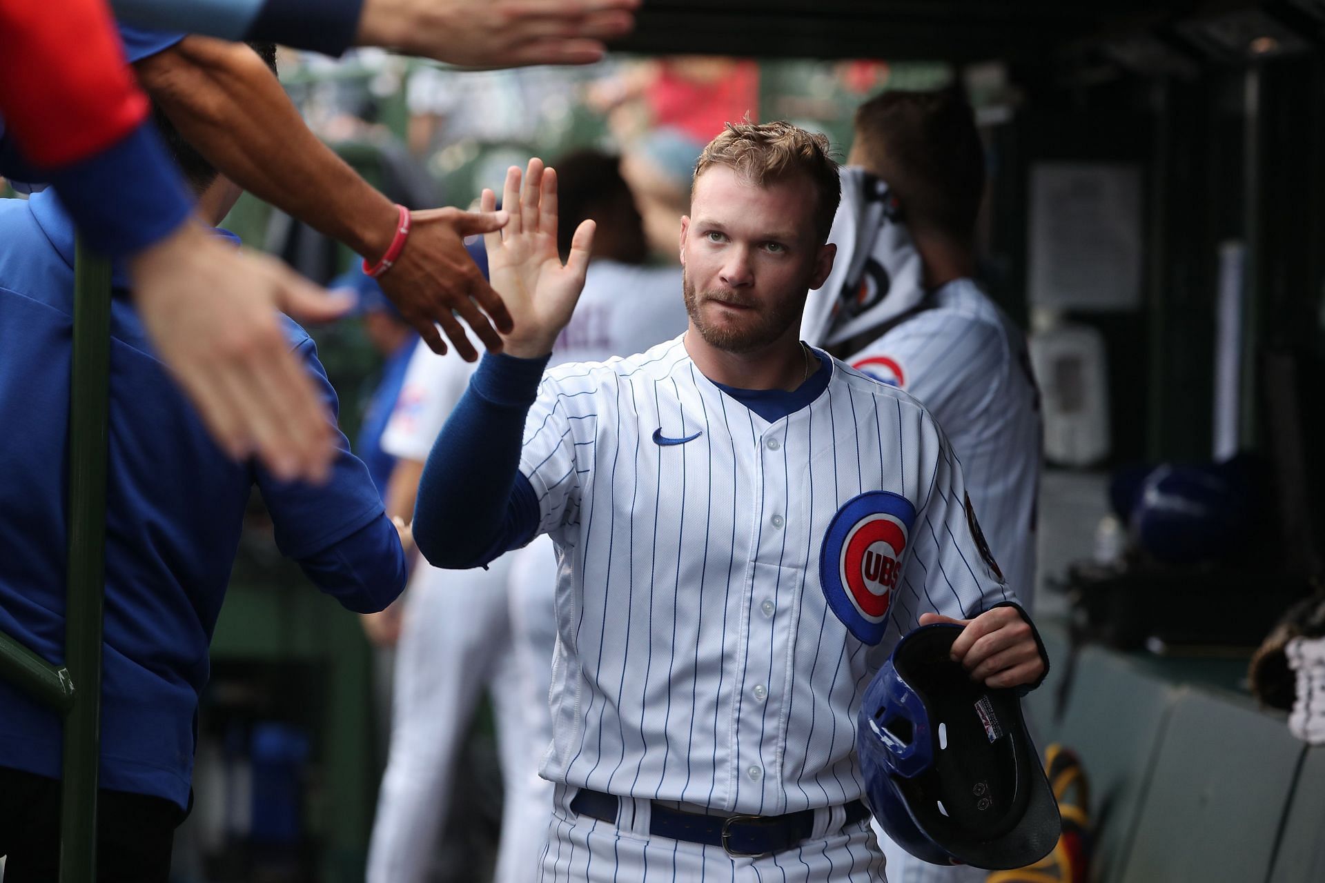 Ian Happ celebrates in the dugout during a New York Mets v Chicago Cubs game.