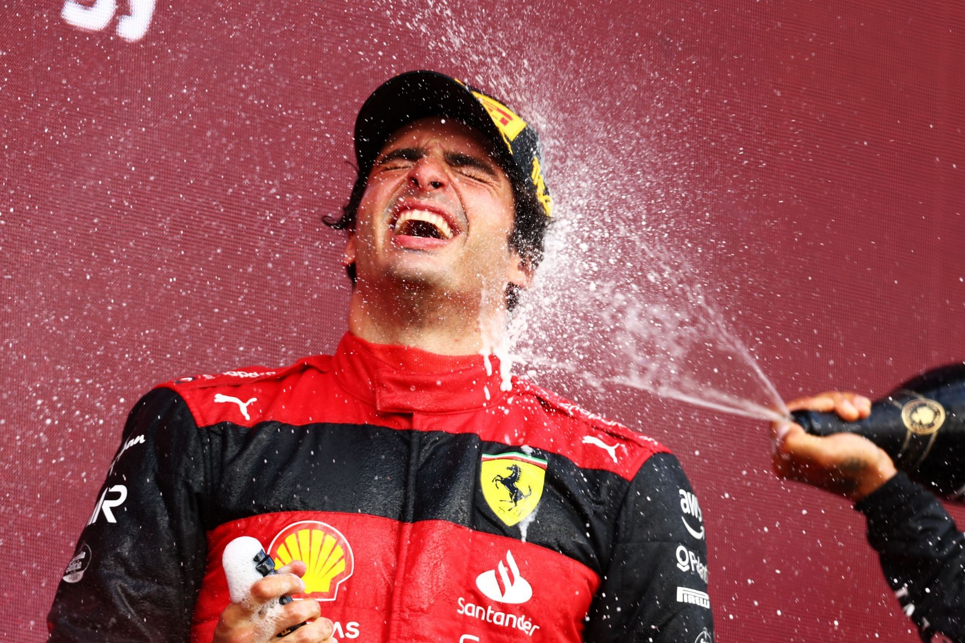 Carlos Sainz celebrates on the podium after winning the 2022 F1 Grand Prix of Great Britain