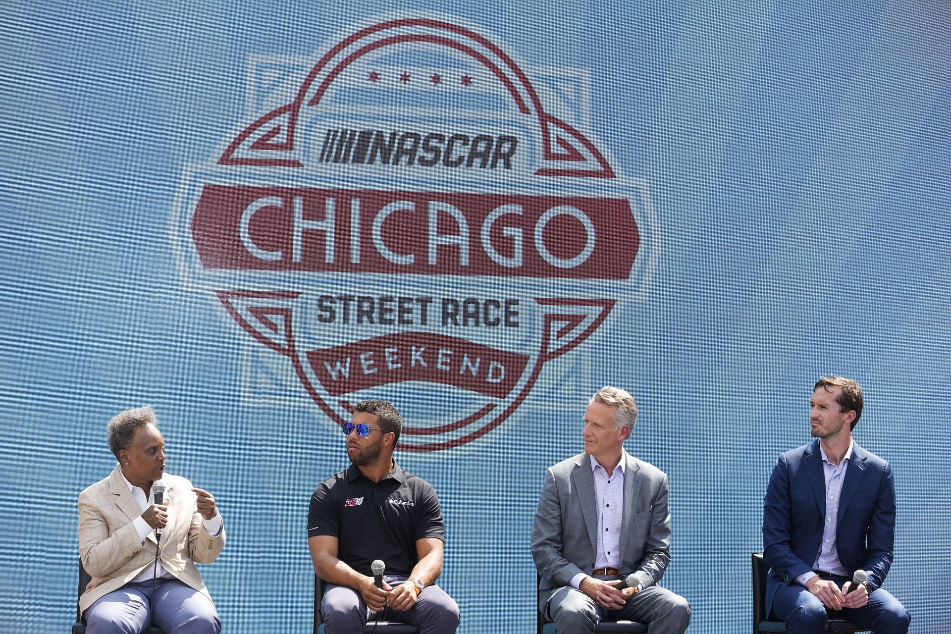 NASCAR President Steve Phelps and Senior Vice President of Strategy and Innovation Ben Kennedy listen as Chicago Mayor Lori Lightfoot speaks during a press conference in promotion of the Chicago Street Race announcement