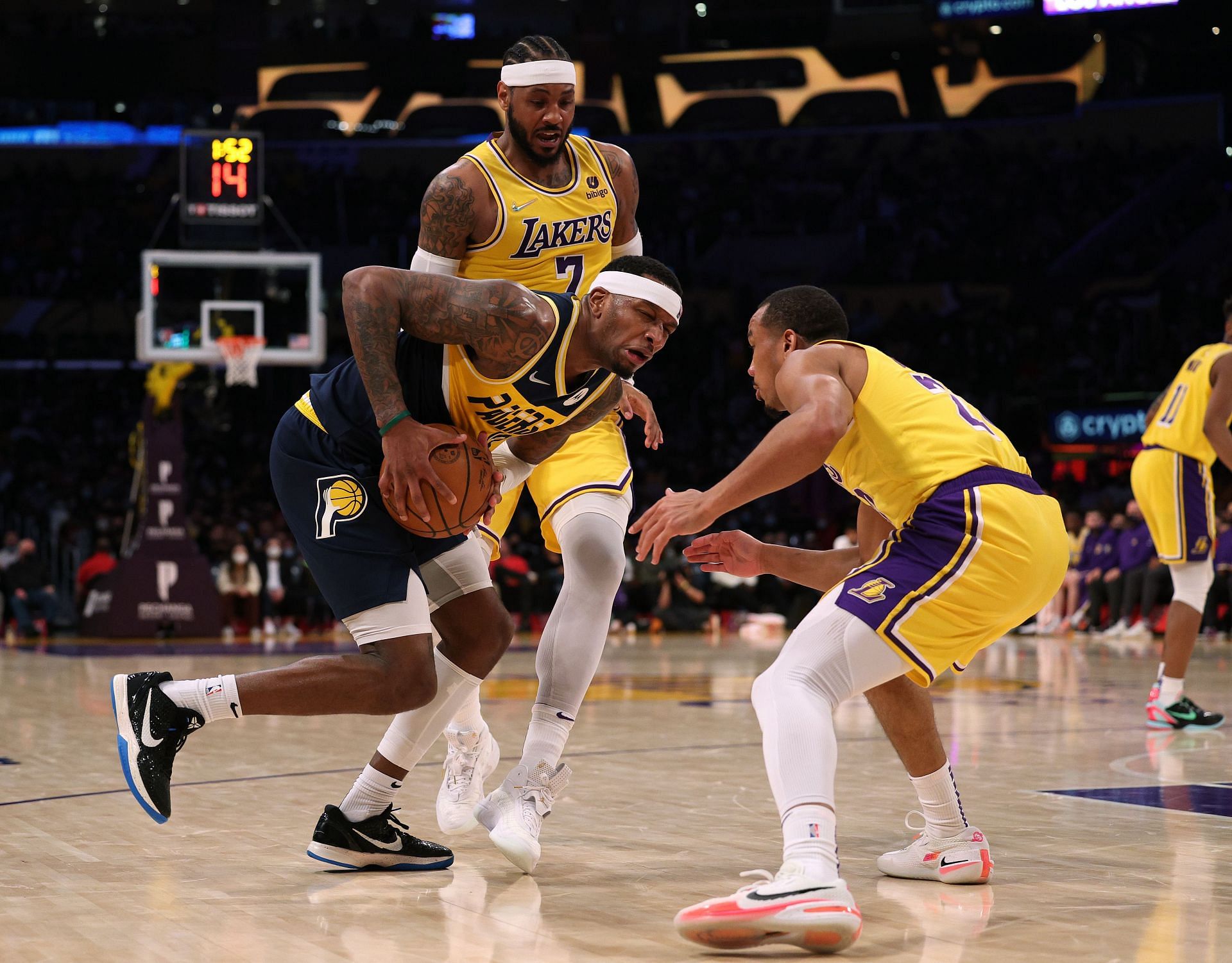Avery Bradley of the LA Lakers defends Torrey Craig of the Indiana Pacers