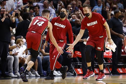 Tyler Herro #14 of the Miami Heat celebrates a three pointer with Duncan Robinson and Max Strus