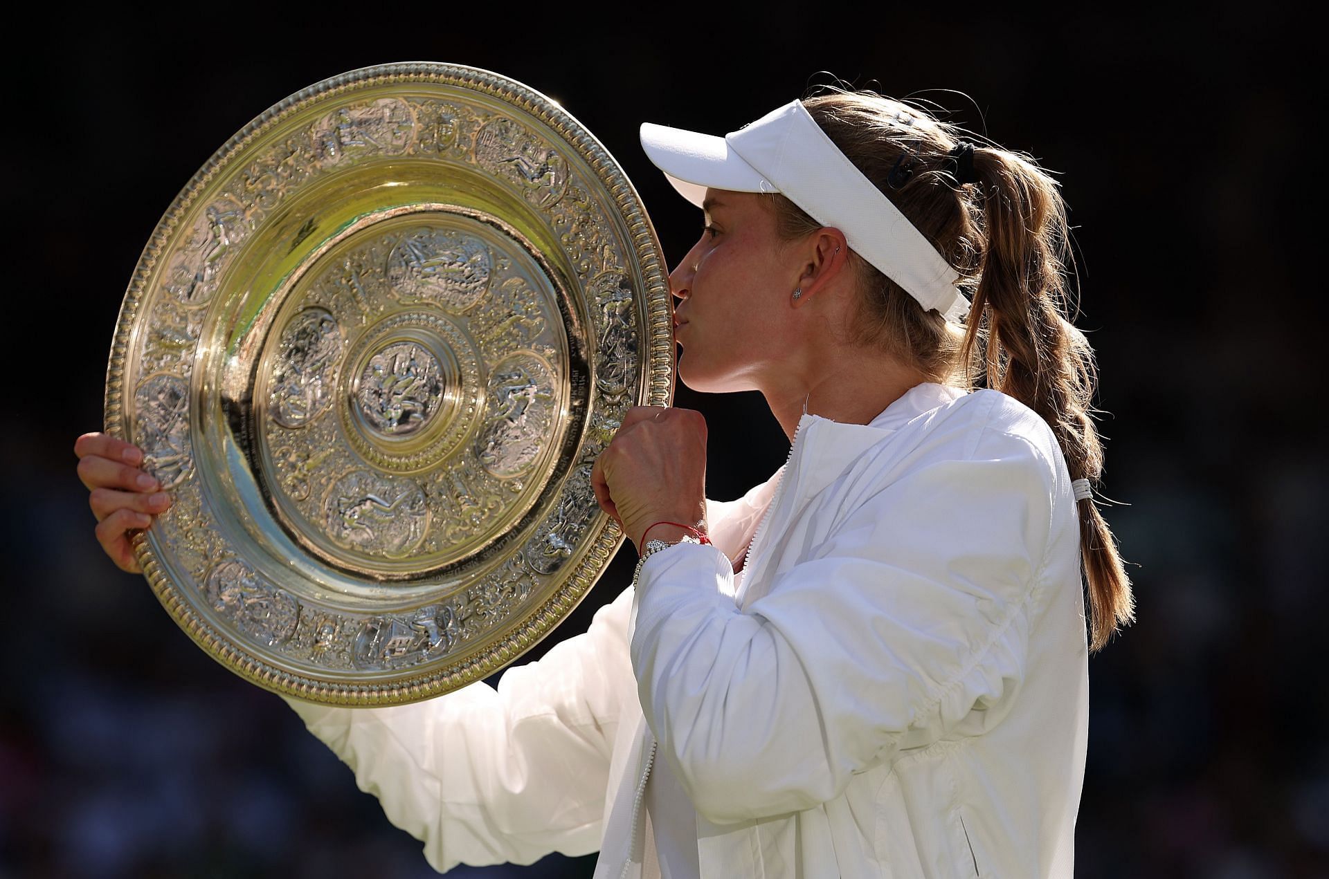 Elena Rybakina kisses the Venus Rosewater Dish &ndash; her first Grand Slam title and first for Kazakh tennis.