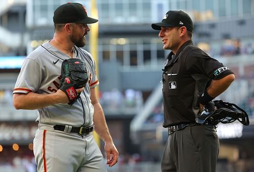 Carlos Rodon of the San Francisco Giants converses with homeplate umpire Pat Hoberg