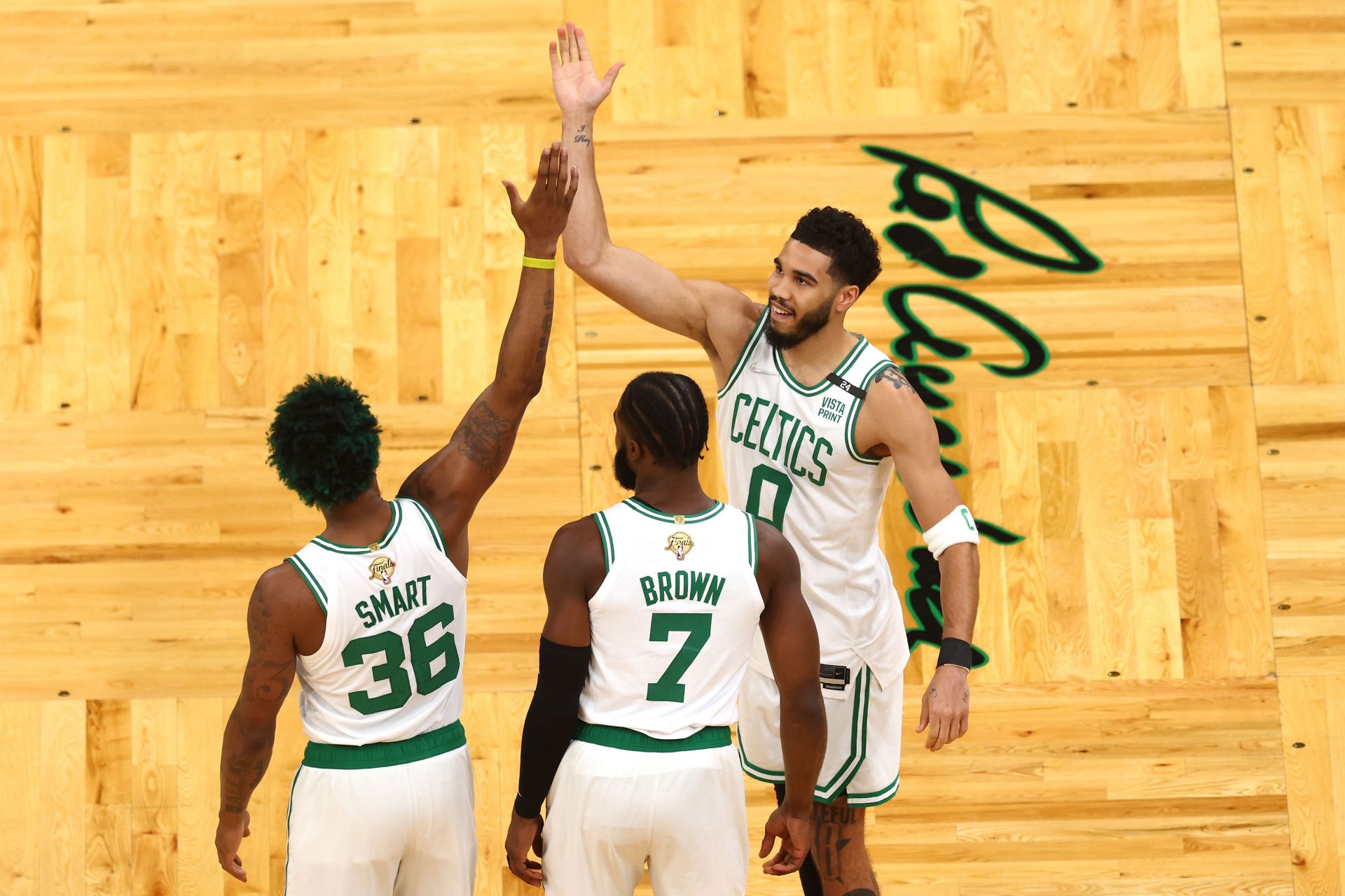 Marcus Smart #36, Jaylen Brown #7 and Jayson Tatum #0 of the Boston Celtics