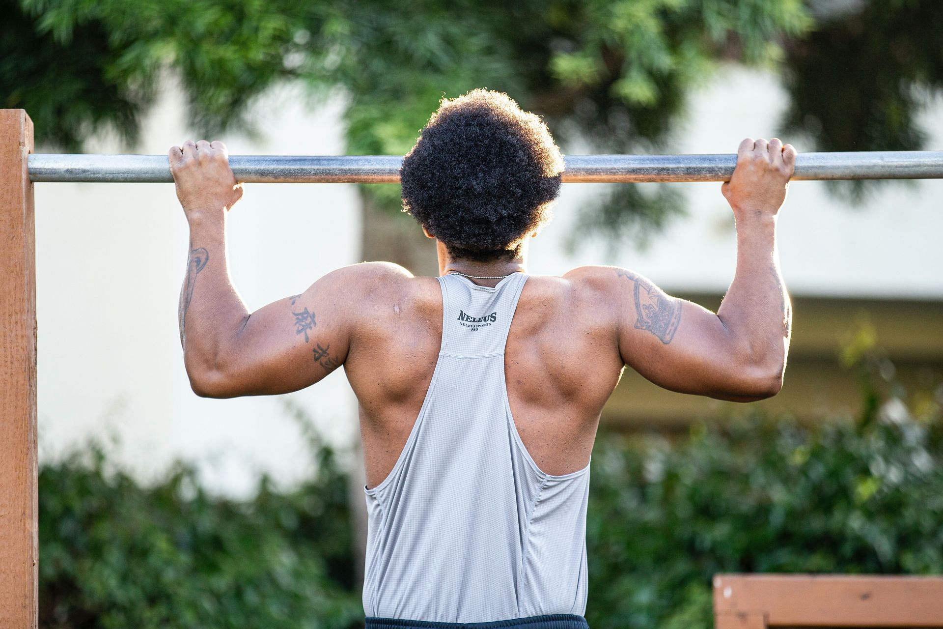 Pull-up bar exercises help in strengthening your arms and back. (Image via Unsplash / Lawrence Crayton)
