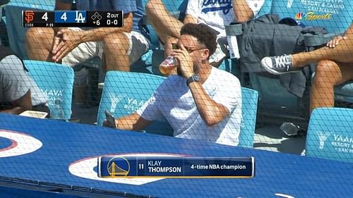 Klay Thompson chugs a glass of beer at the Dodgers-Giants MLB game [Photo source: NBC Sports]