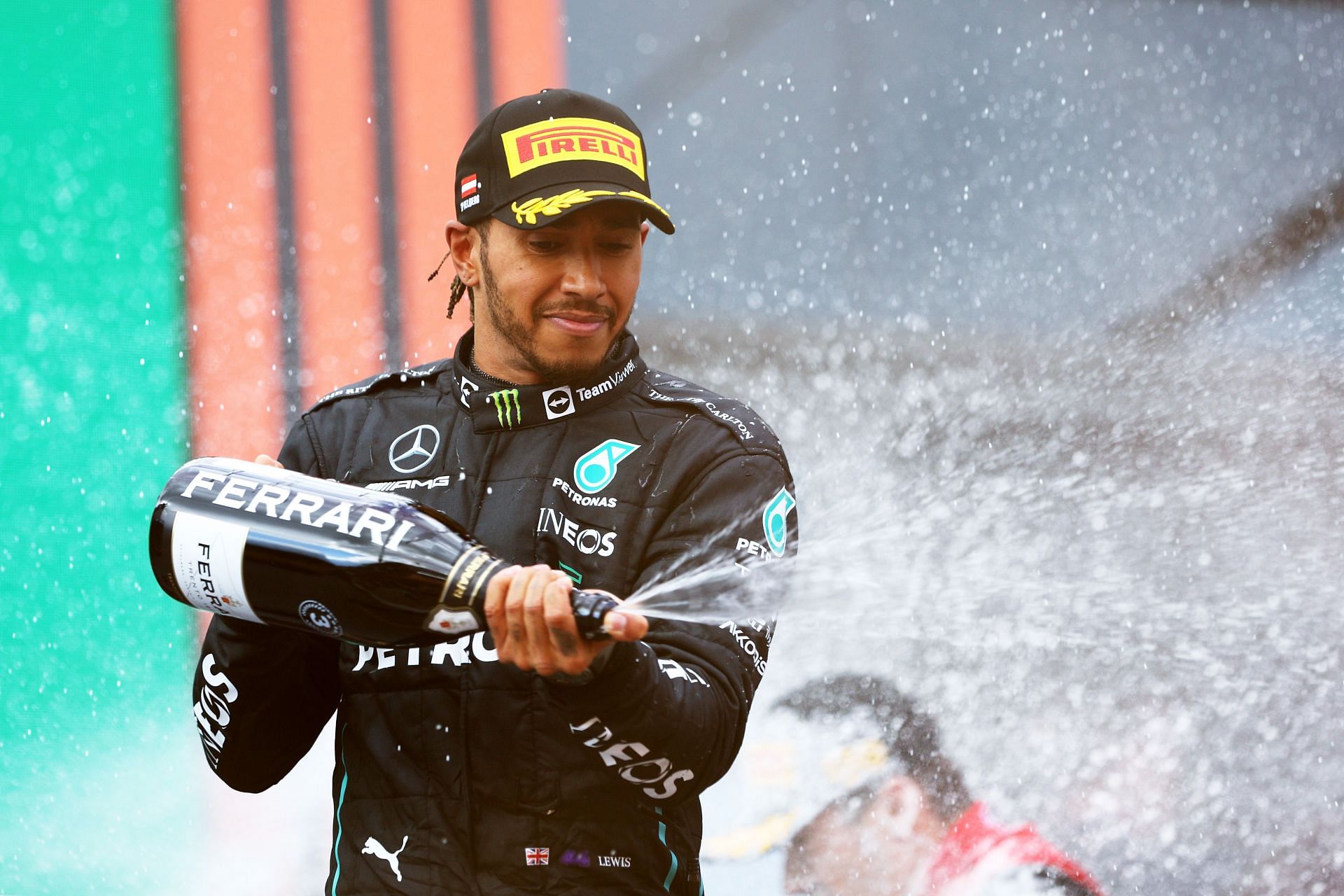 Third-placed Lewis Hamilton celebrates on the podium during the F1 Grand Prix of Austria at Red Bull Ring on July 10, 2022, in Spielberg, Austria (Photo by Clive Rose/Getty Images)