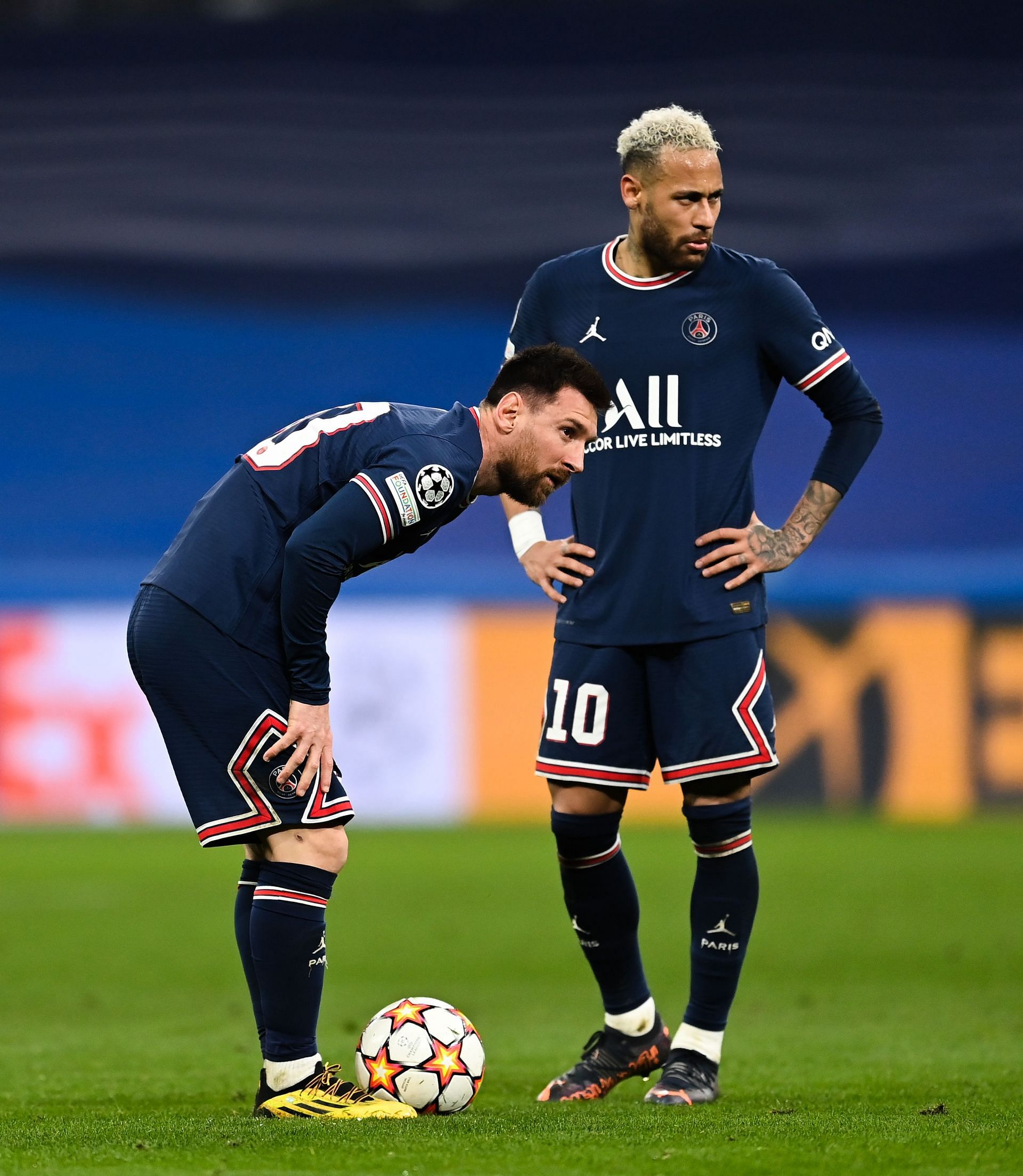 Lionel Messi (left) prepares to take a free kick while Neymar watches on.