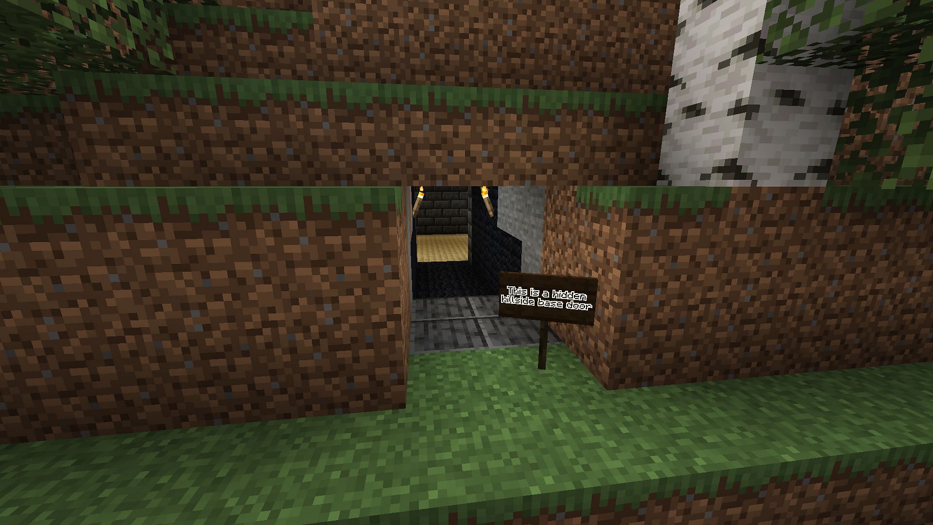 This wireless door was used to hide a dirt door for a hillside base (Image via Minecraft)
