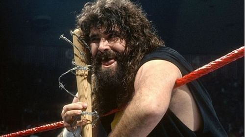 Mick Foley as Cactus Jack with his trusted "Barbie"