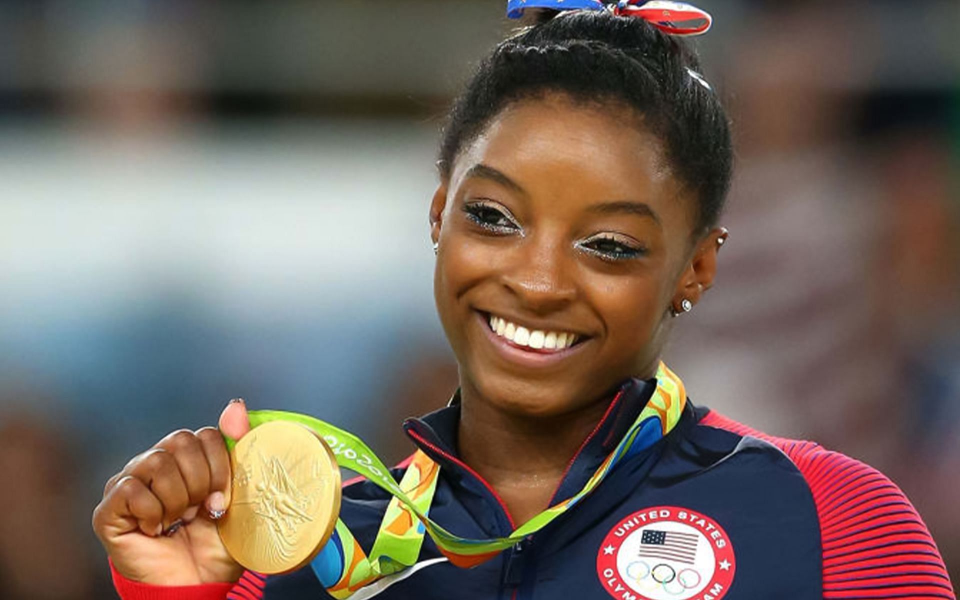 Simone Biles with one of her gold medals at the 2016 Summer Olympics in Tokyo (Image via Getty Images)