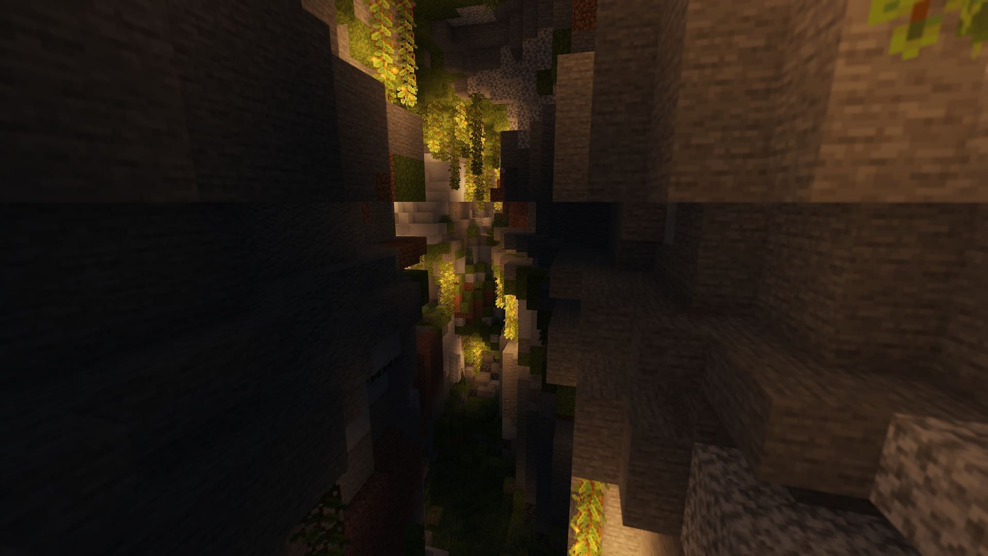 A lush ravine made up of different kinds of stone (Image via Minecraft)